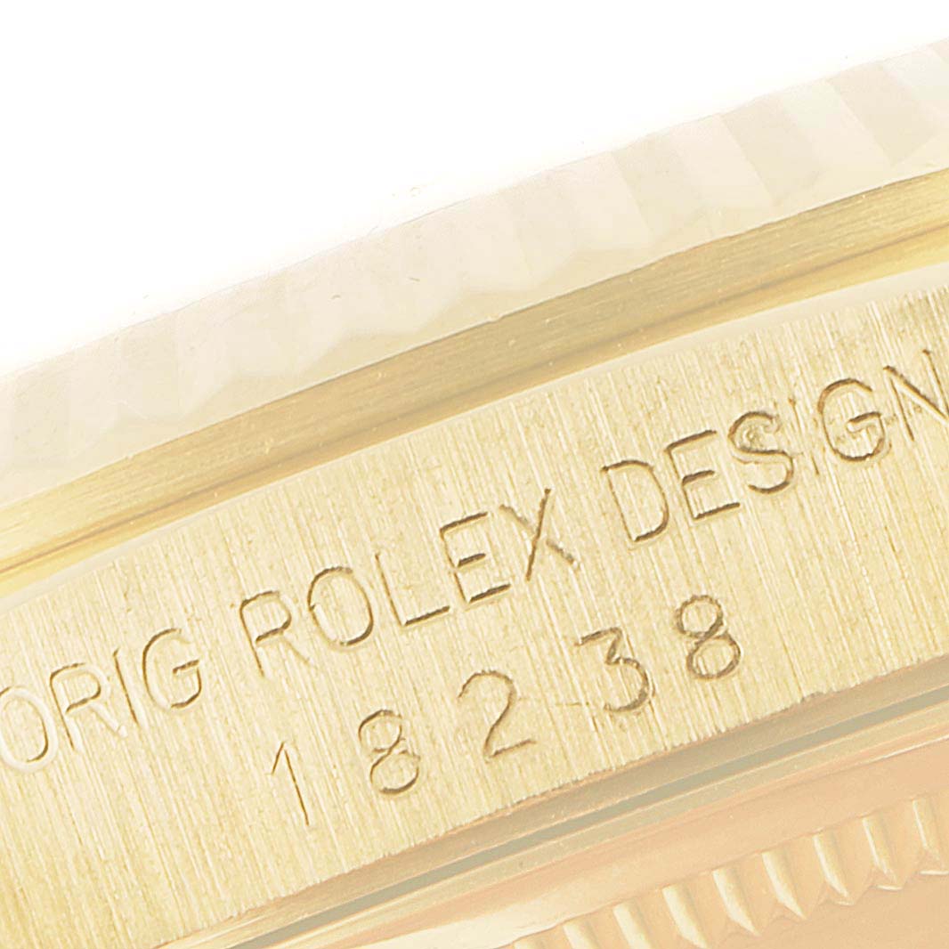 Close-up of the side of a Rolex President 18238 Men's Yellow Gold Champagne Dial 18238 Men's Yellow Gold Champagne Dial model watch, showing the engraving "ORIG ROLEX DESIGN 18238."