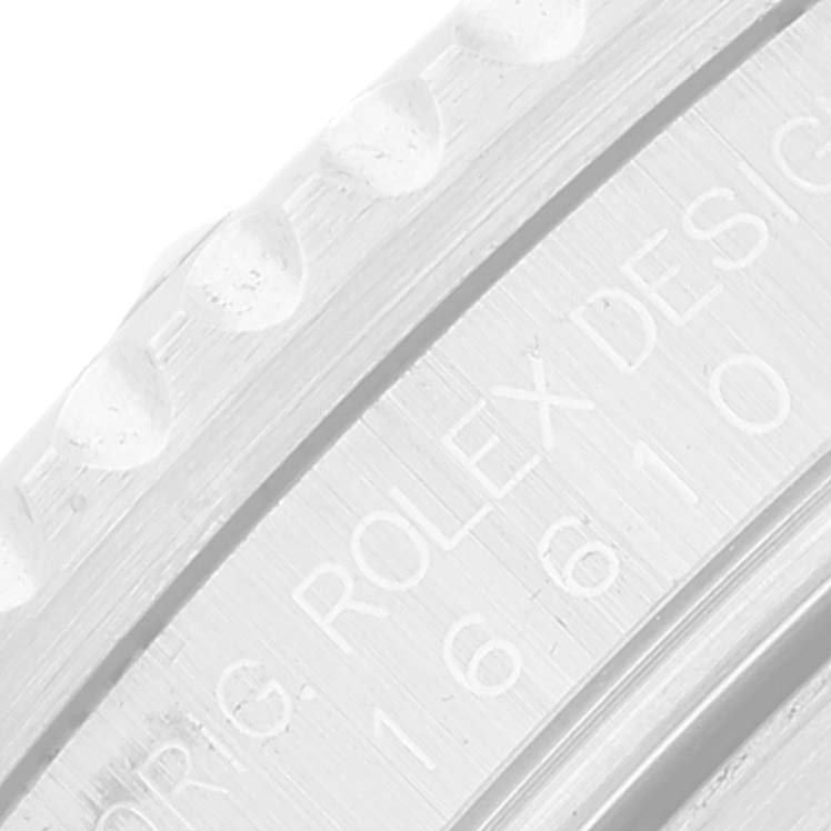 This image shows a close-up of the engraved details on the bezel and case of a Rolex Submariner 16610 Men's Stainless Steel Black Dial 16610 Men's Stainless Steel Black Dial watch.