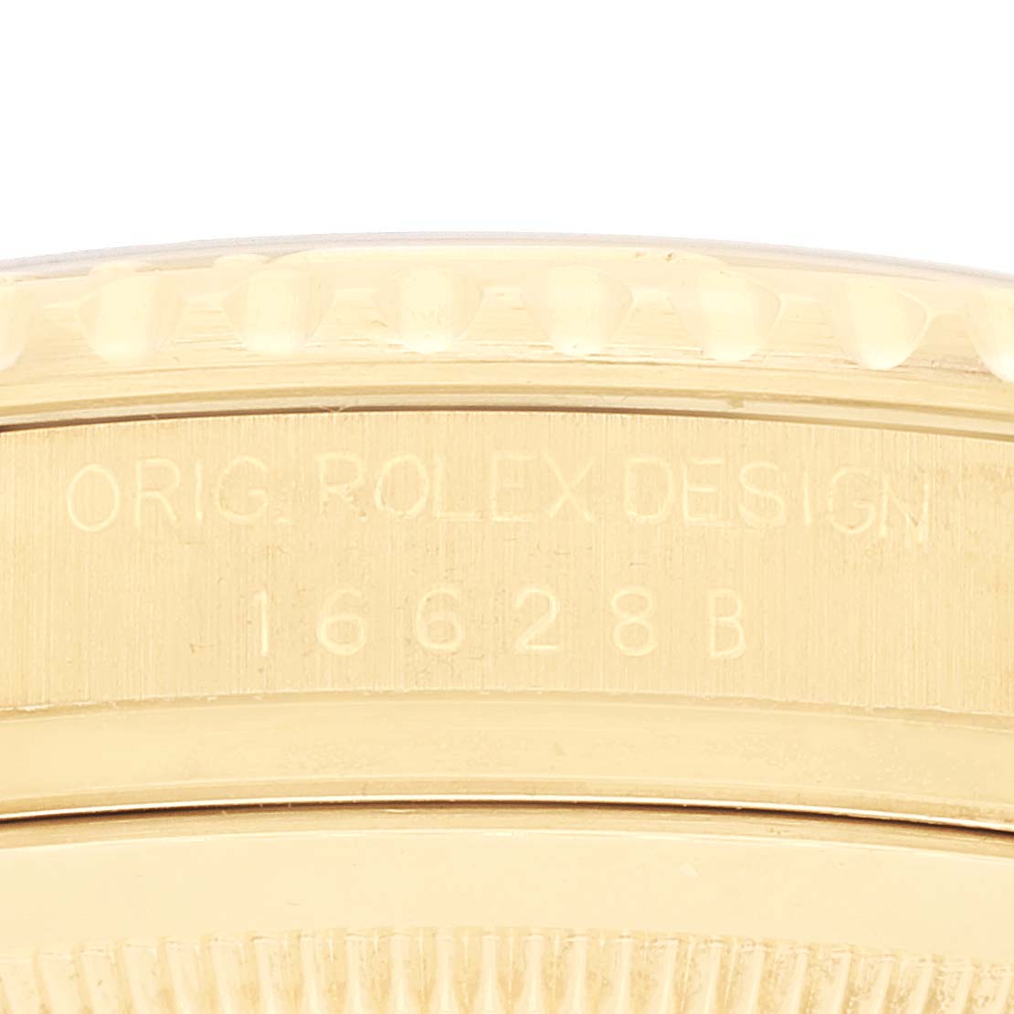 This image shows a close-up of the case back engraving on a Rolex Yacht-Master 16628 Men's Yellow Gold White Dial 16628 Men's Yellow Gold White Dial model, highlighting the text "ORIG. ROLEX DESIGN 16628B."