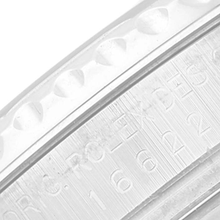 This is a close-up of a Rolex Yacht-Master 16622 Men's Stainless Steel Silver Dial 16622 Men's Stainless Steel Silver Dial watch, showing part of the bezel and engraved text on the side.
