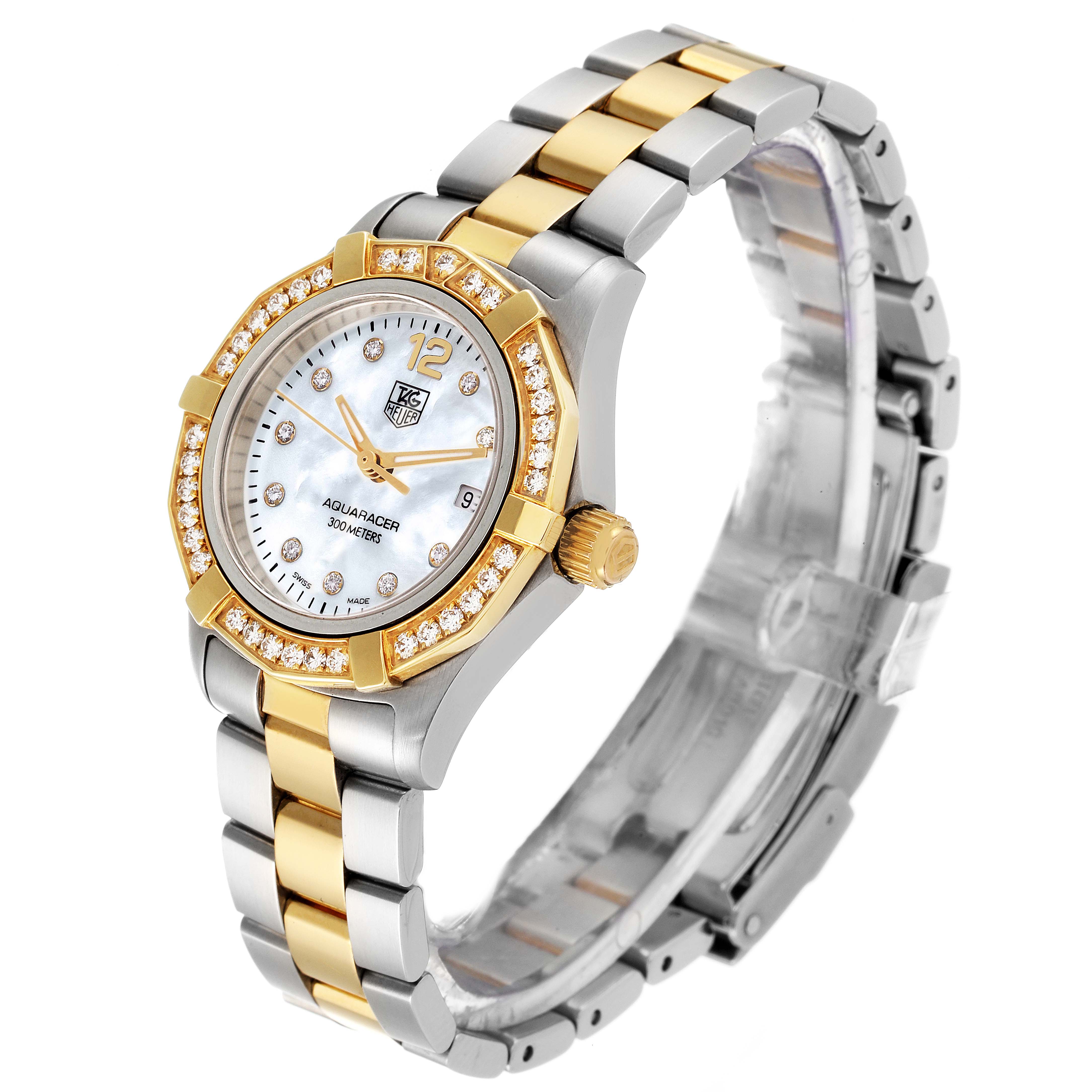 This image shows a side-angle view of a Tag Heuer Aquaracer WAF1450.BA0825 Women's Steel and Gold (two tone) Mother of Pearl Dial WAF1450.BA0825 Women's Steel and Gold (two tone) Mother of Pearl Dial watch with a silver and gold bracelet, diamond bezel, and round face with gold accents.