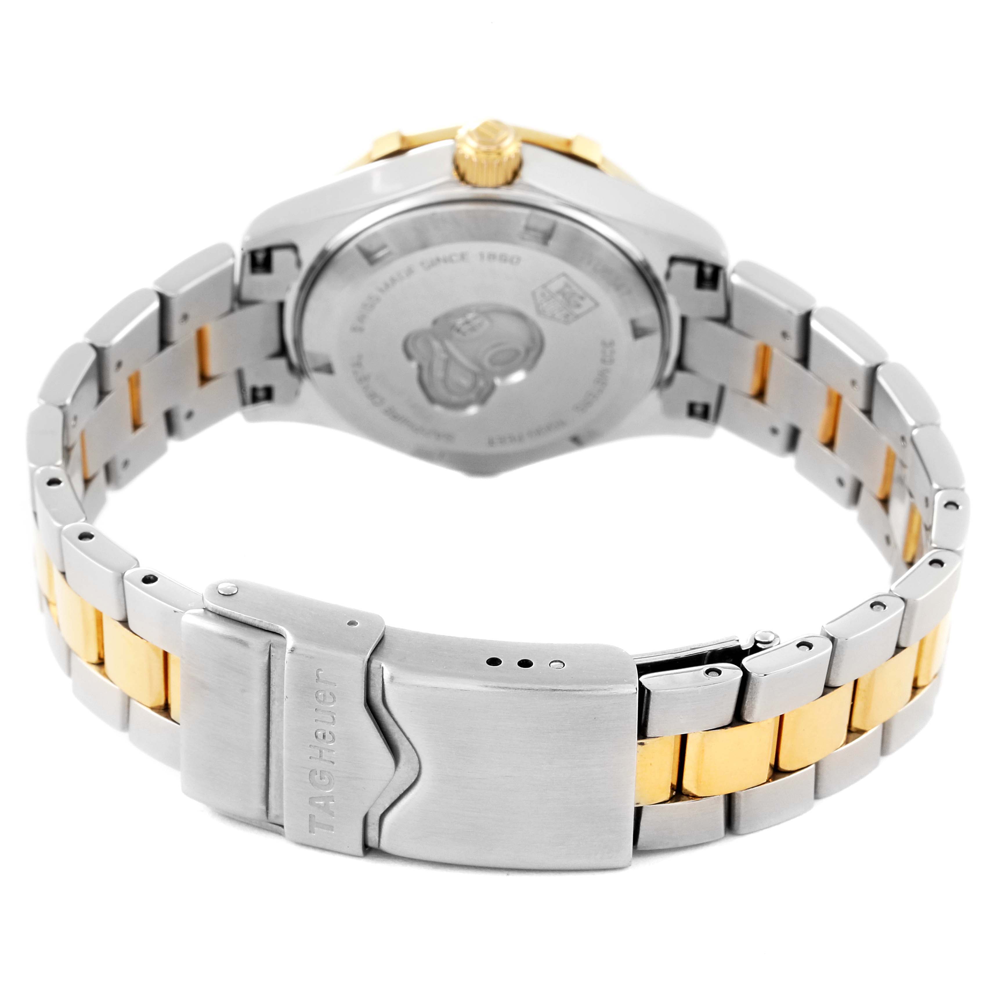 The image shows the back view of a Tag Heuer Aquaracer WAF1450.BA0825 Women's Steel and Gold (two tone) Mother of Pearl Dial WAF1450.BA0825 Women's Steel and Gold (two tone) Mother of Pearl Dial watch, highlighting the case back and metal bracelet with a folding clasp.
