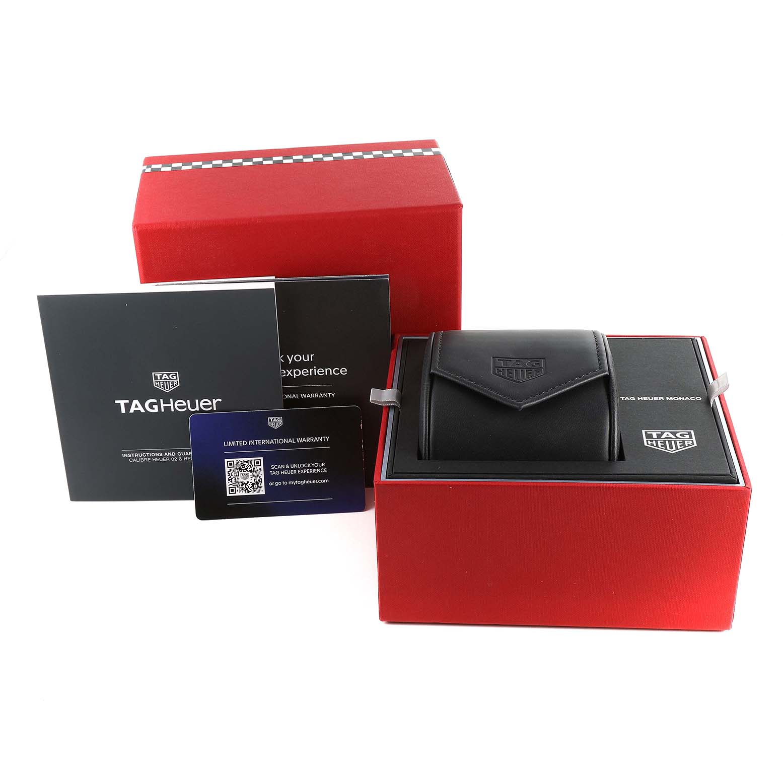 The image shows the accessories of a Tag Heuer Monaco CBL2180 Men's Titanium Black Dial CBL2180 Men's Titanium Black Dial watch, including a box, warranty card, instruction booklets, and a watch case.