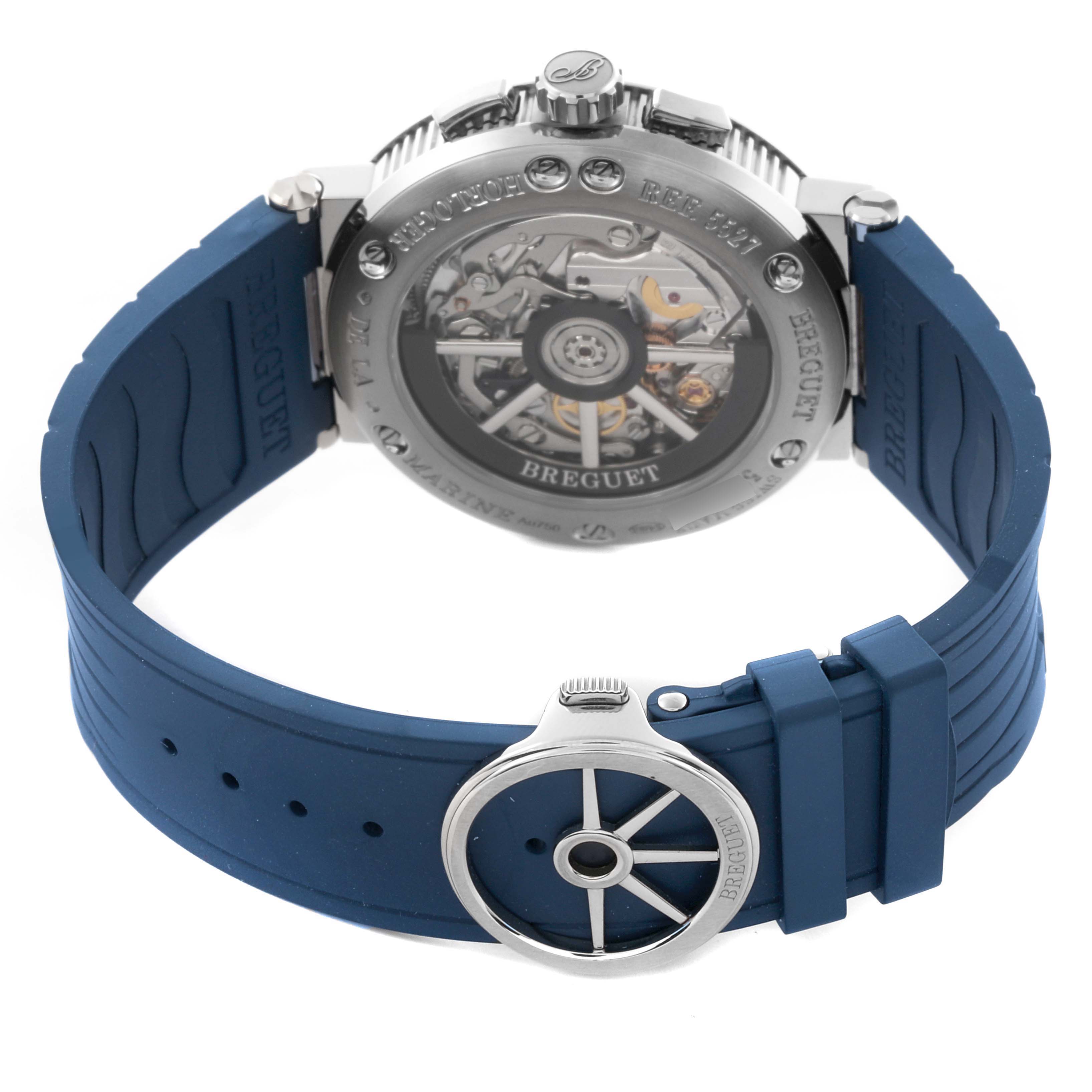 The Breguet Marine 5527BB/Y2/5WV Men's White Gold Blue Dial 5527BB/Y2/5WV Men's White Gold Blue Dial watch is shown from the back, highlighting its blue strap and the intricate movement inside the case.