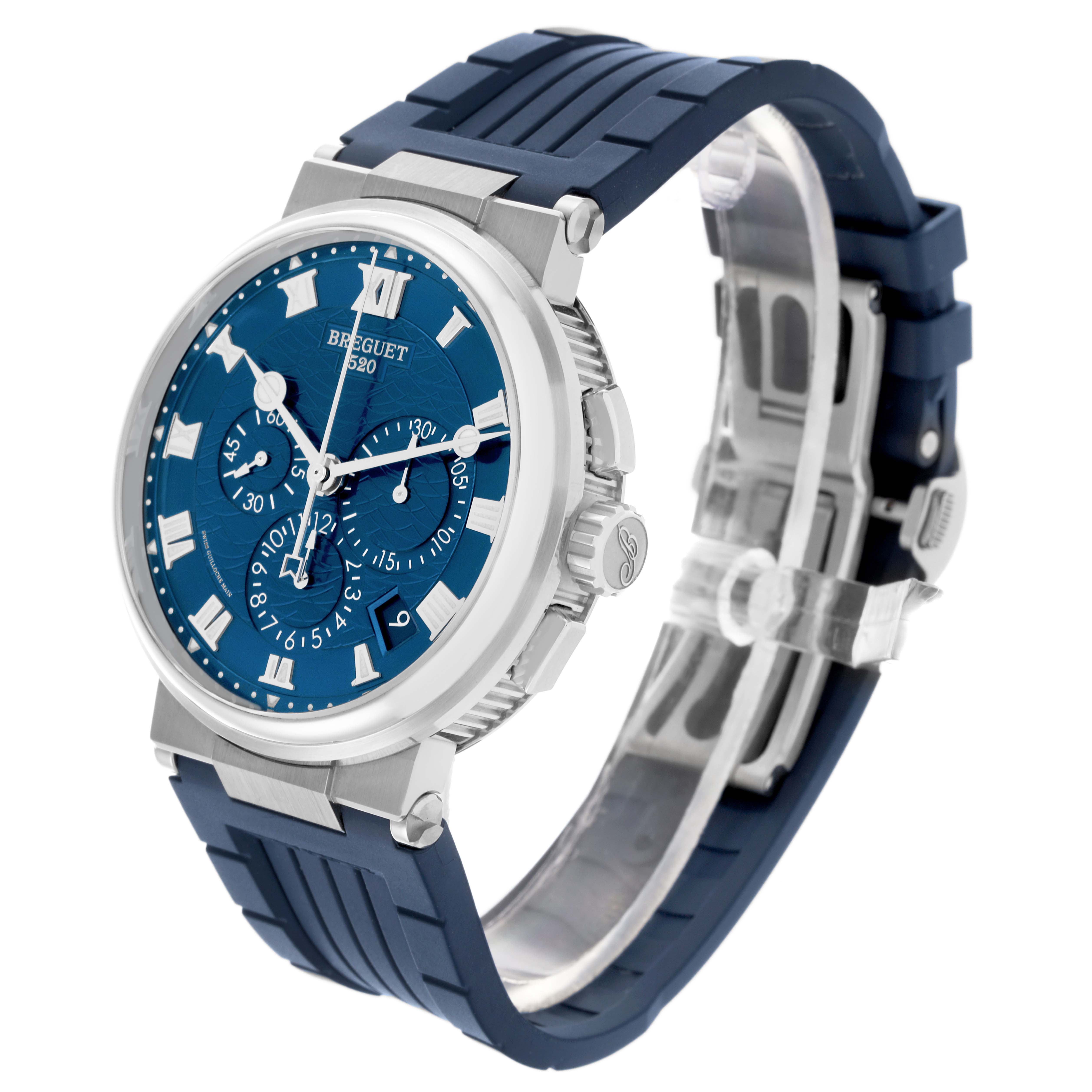 The Breguet Marine 5527BB/Y2/5WV Men's White Gold Blue Dial 5527BB/Y2/5WV Men's White Gold Blue Dial watch is shown at a three-quarter view, highlighting the blue dial, bezel, pushers, and rubber strap.