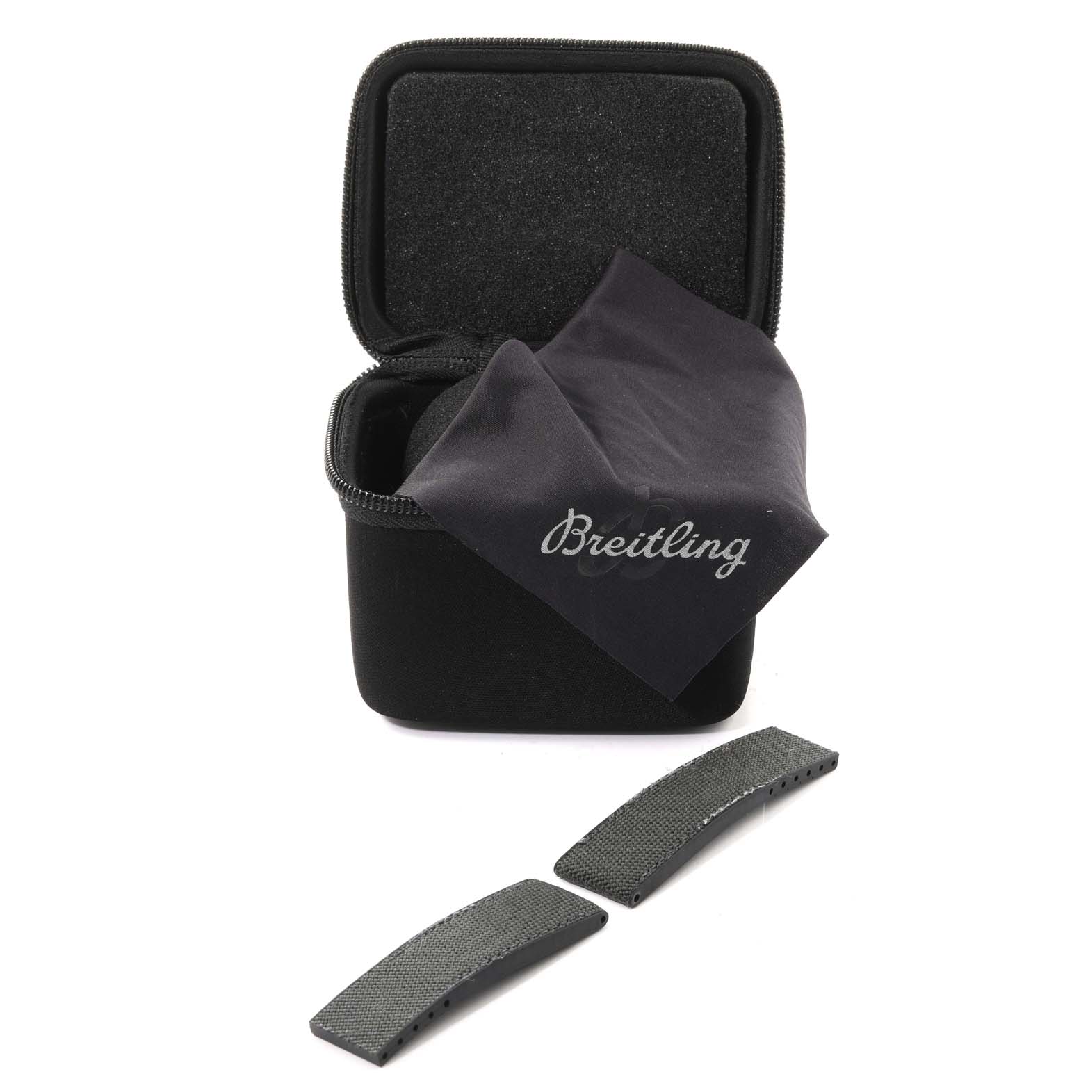 The image displays a Breitling Avenger E13383 Men's Titanium Grey Dial E13383 Men's Titanium Grey Dial watch case with a cleaning cloth and two strap pieces from a top-down angle.