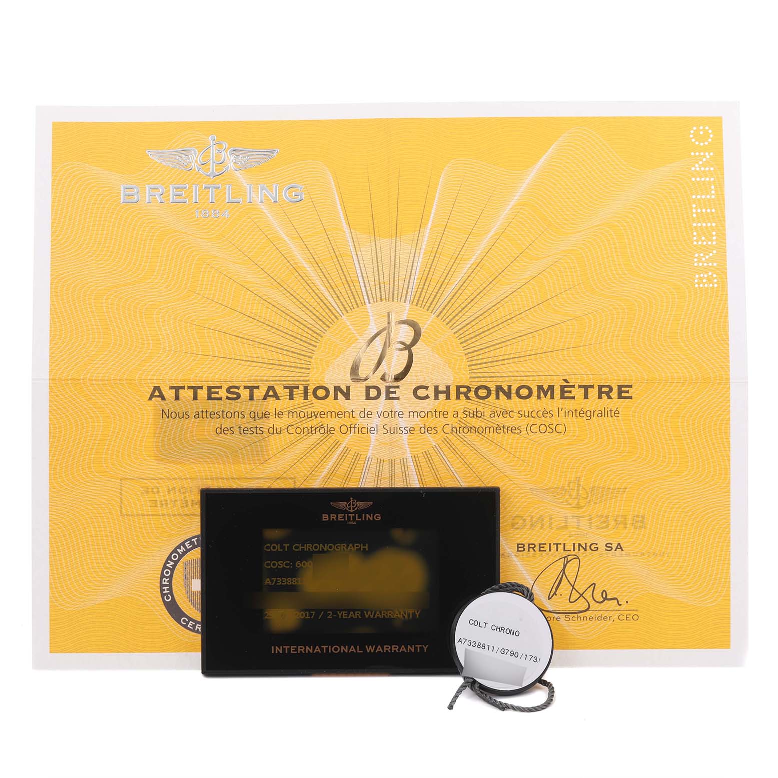 The image shows Breitling Colt A73388 Men
s Stainless Steel White Dial A73388 Men
s Stainless Steel White Dial model warranty card, certificate, and a tag with the watch model details.