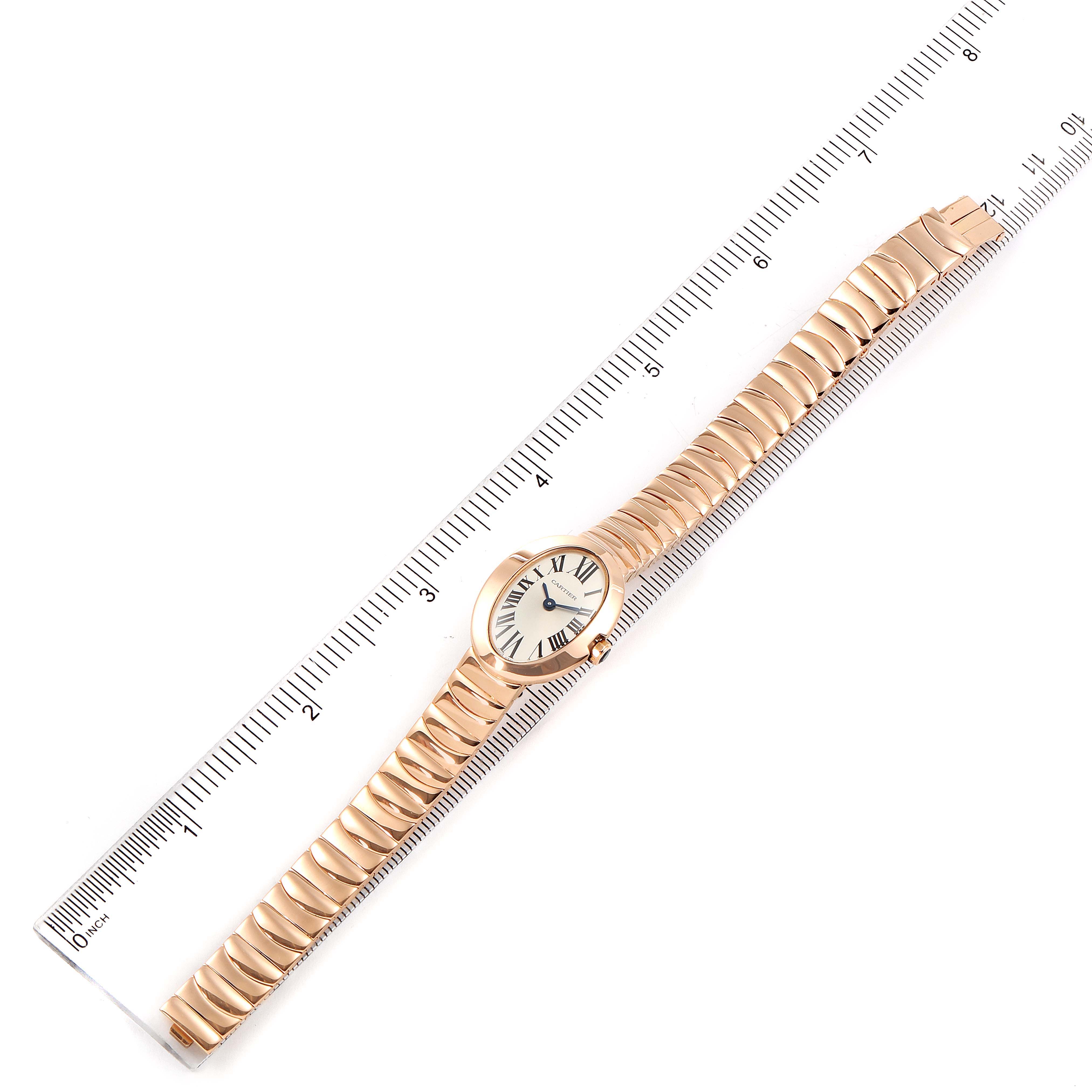The Cartier Baignoire W8000015 Women's Rose Gold Silver Dial W8000015 Women's Rose Gold Silver Dial watch is shown from a top-down view, displaying the entire watch next to a ruler.