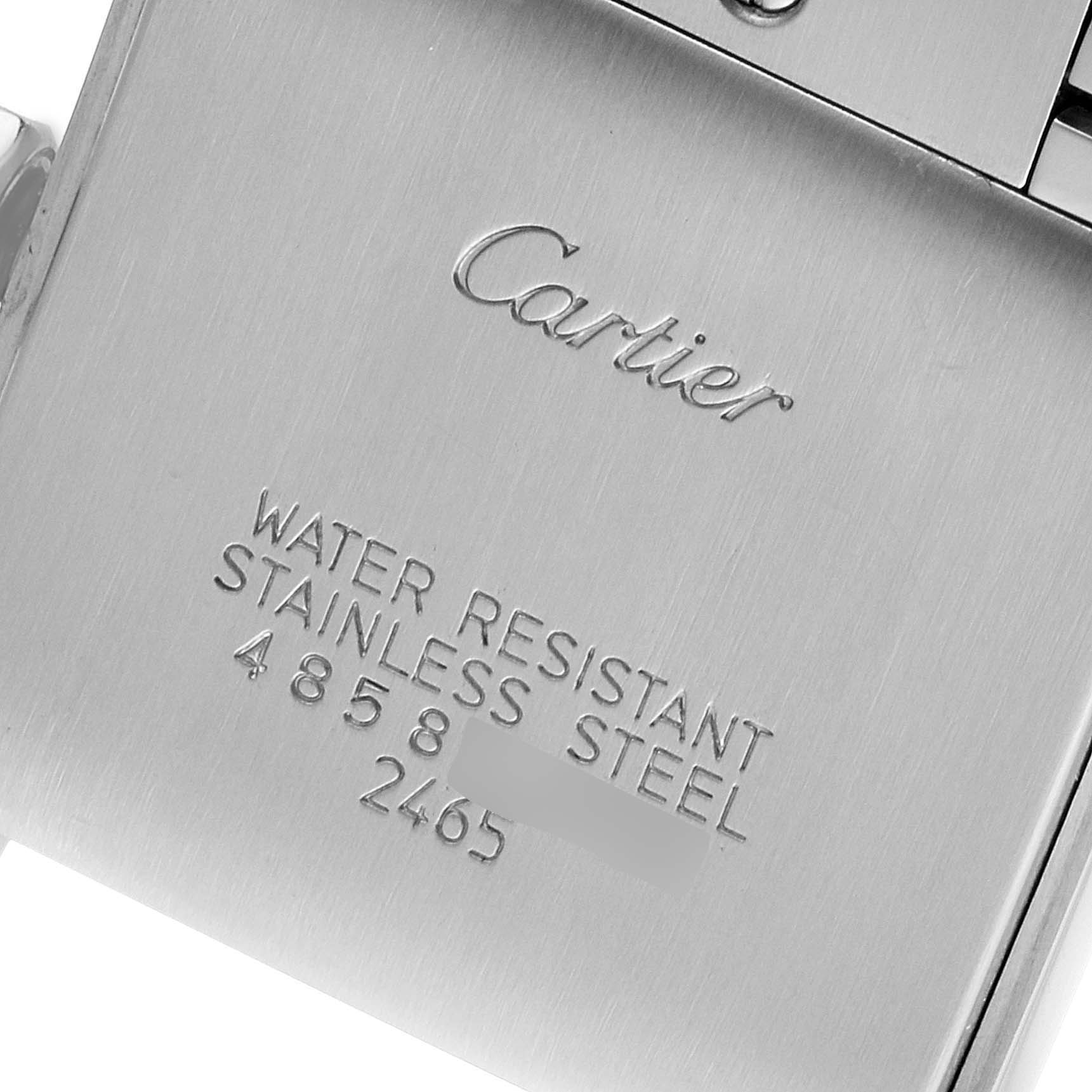 The image shows the back of a Cartier Tank Francaise W51011Q3 Women's Stainless Steel Silver Dial W51011Q3 Women's Stainless Steel Silver Dial watch with engravings about its water resistance and stainless steel material.