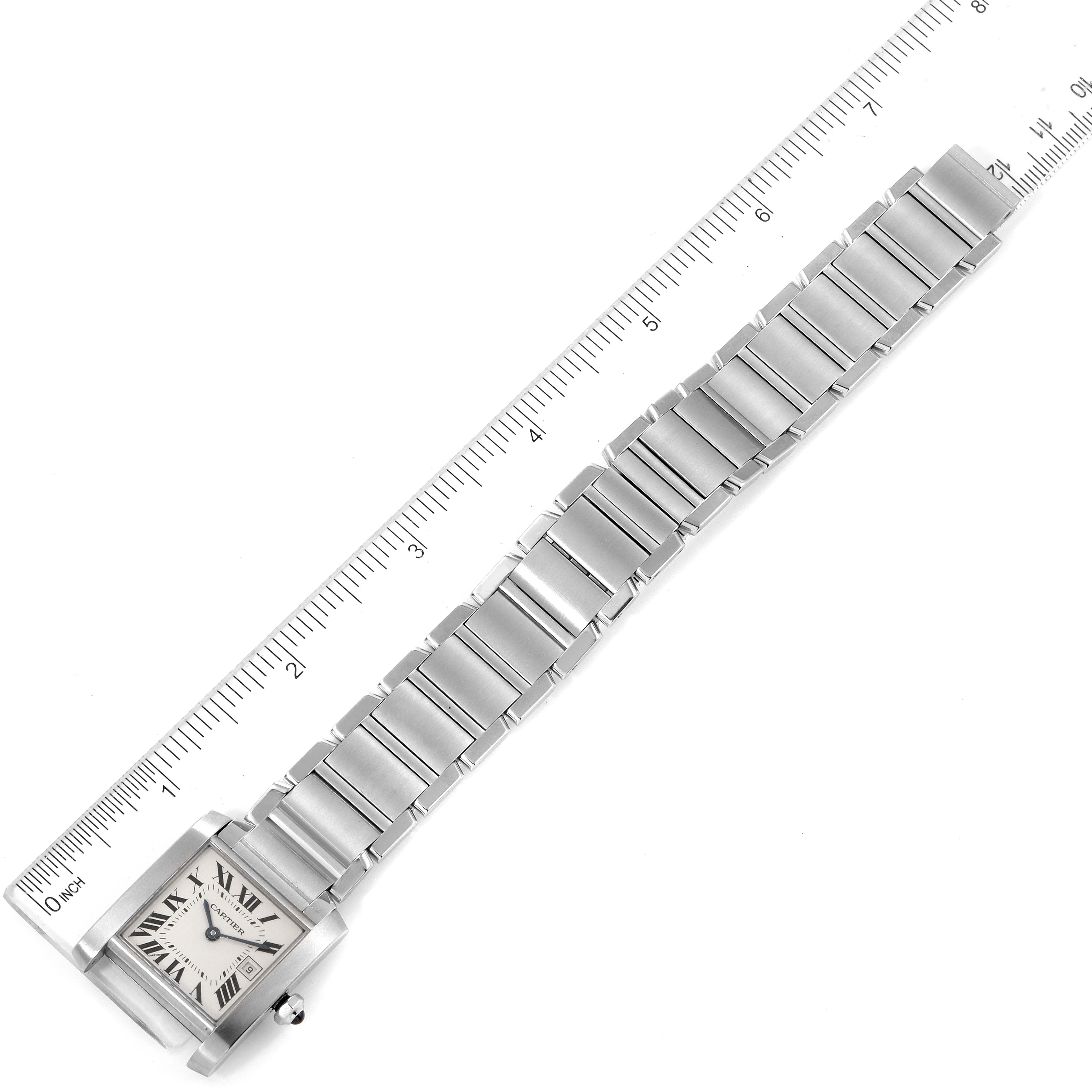 The Cartier Tank Francaise W51011Q3 Women's Stainless Steel Silver Dial W51011Q3 Women's Stainless Steel Silver Dial watch is shown laid flat with a ruler next to it, highlighting its length and bracelet design.