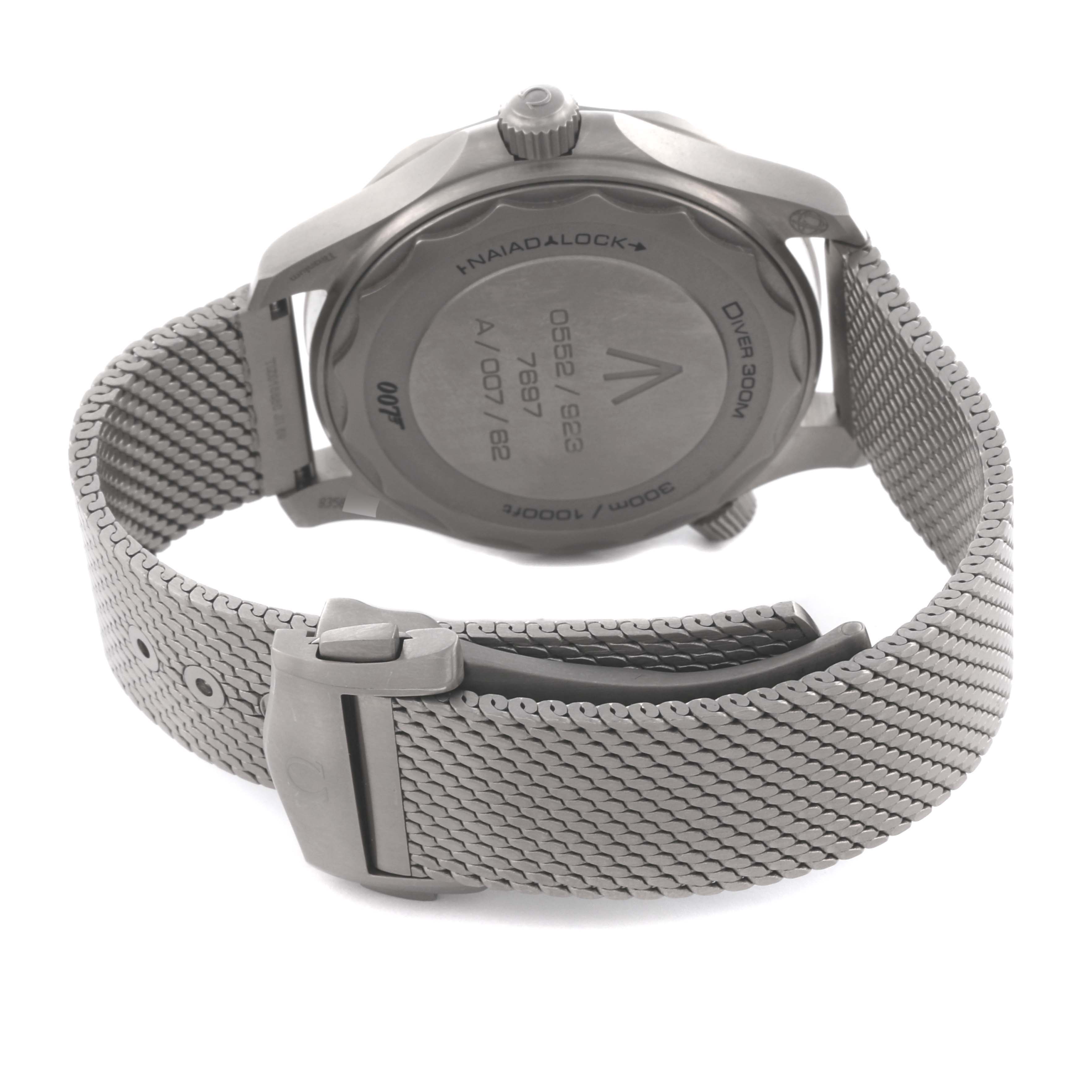 The image shows the back of an Omega Seamaster 210.90.42.20.01.001 Men's Titanium Brown Dial 210.90.42.20.01.001 Men's Titanium Brown Dial watch and its clasped stainless steel mesh bracelet.