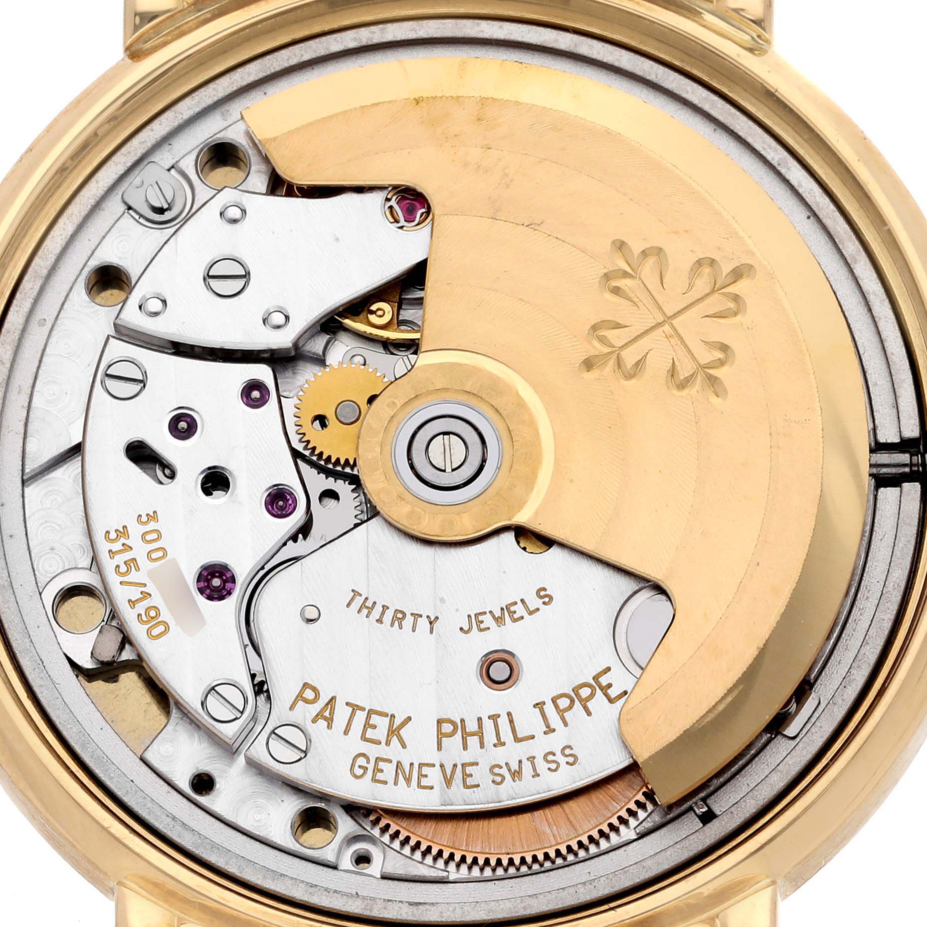 The image shows the movement of a Patek Philippe Calatrava 3802/200 Men's Yellow Gold White Dial 3802/200 Men's Yellow Gold White Dial watch from a back angle, highlighting the rotor and intricate components.