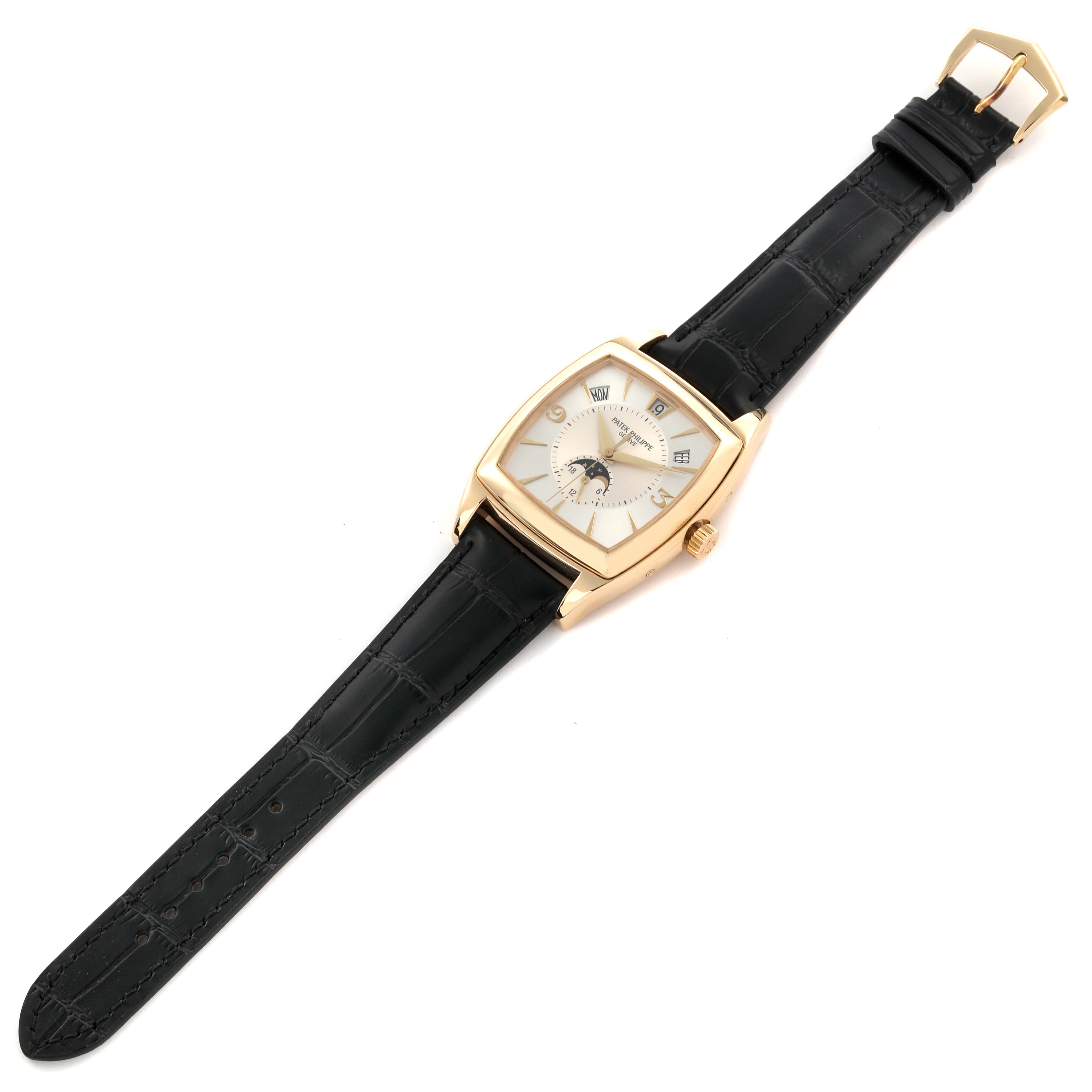 The Patek Philippe Gondolo 5135J-001 Men's Yellow Gold Silver Dial 5135J-001 Men's Yellow Gold Silver Dial watch is shown from a top view, displaying its case, dial, crown, and leather strap.