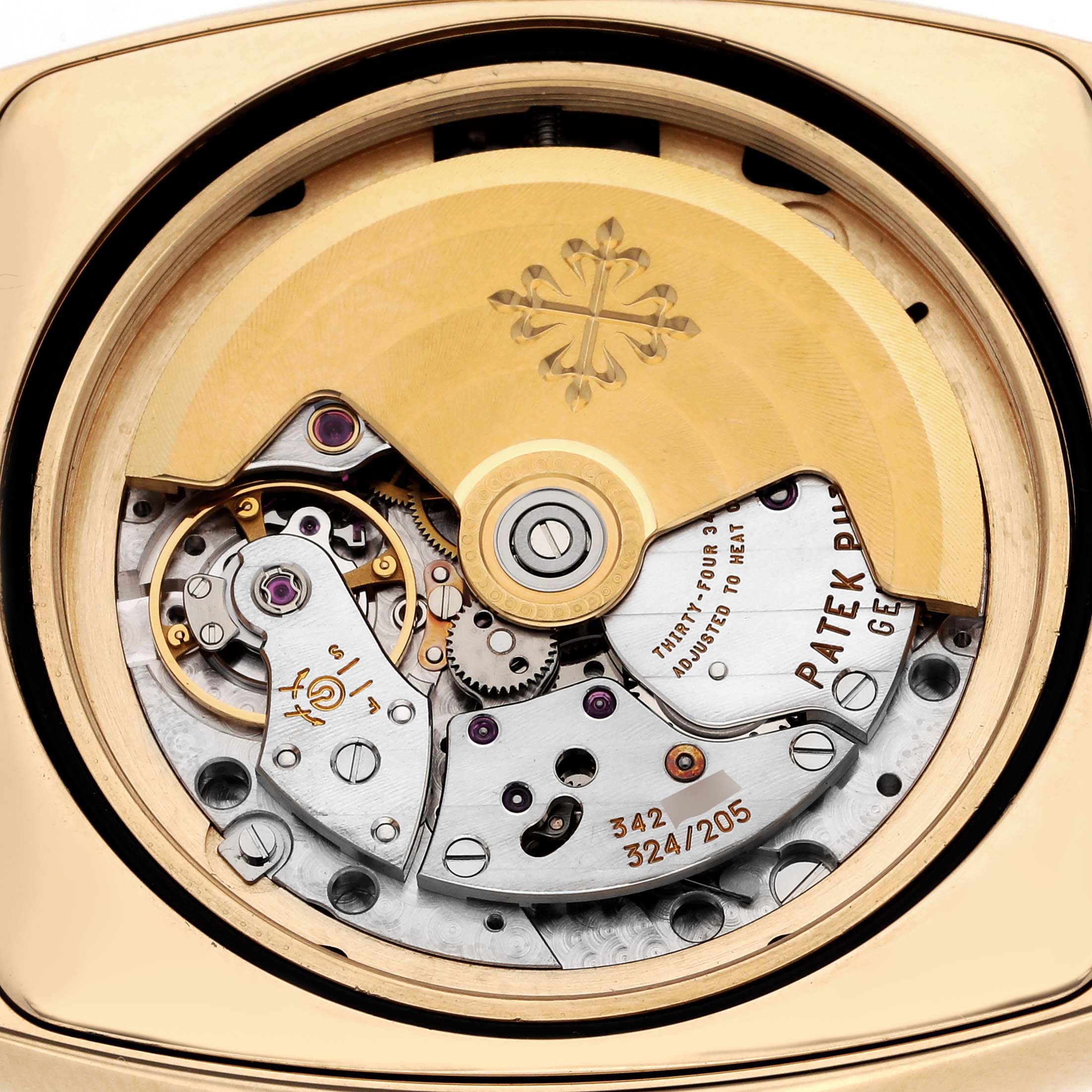 The image shows the movement of a Patek Philippe Gondolo 5135J-001 Men's Yellow Gold Silver Dial 5135J-001 Men's Yellow Gold Silver Dial watch from a rear angle, highlighting its intricate mechanics.
