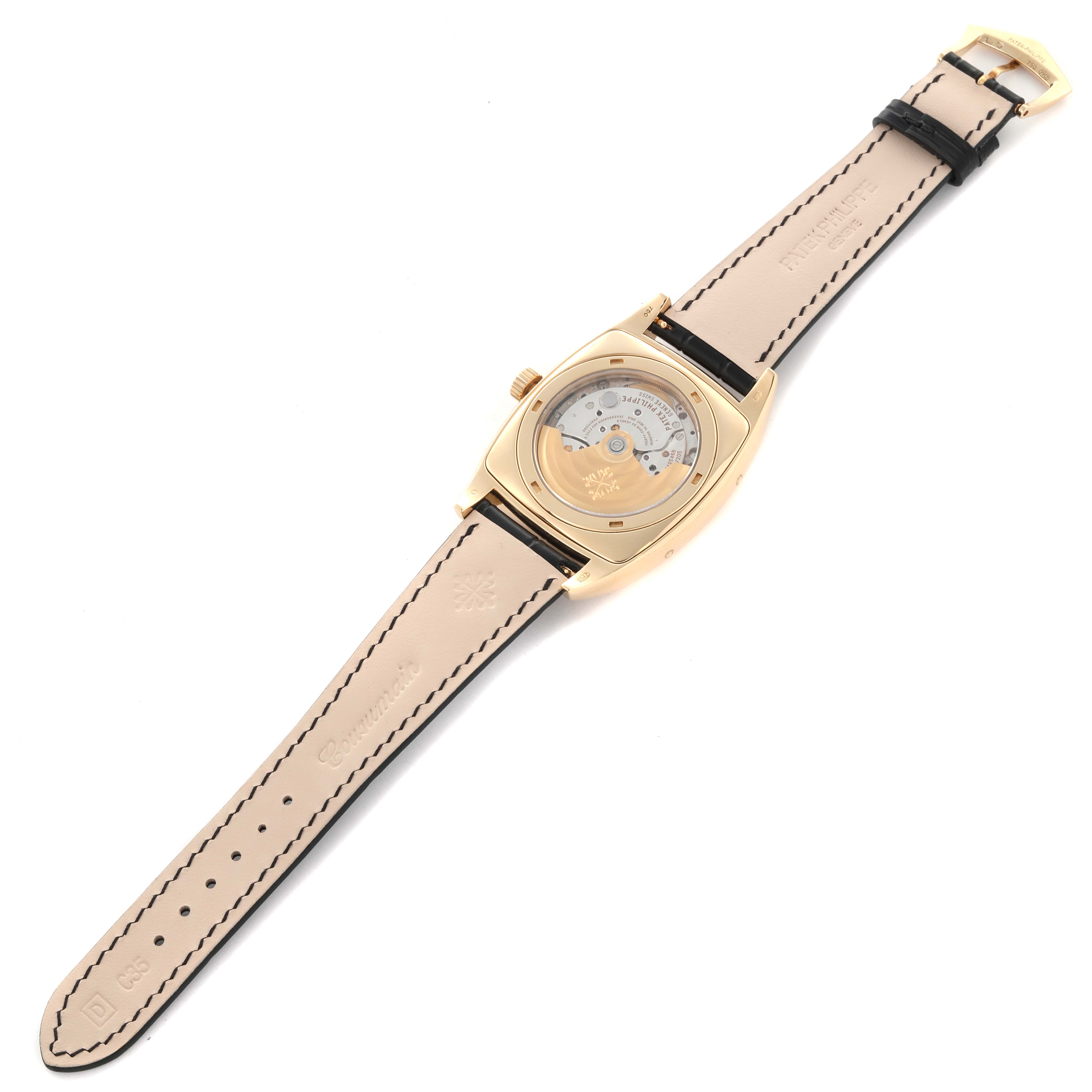 The image shows the back view of the Patek Philippe Gondolo 5135J-001 Men's Yellow Gold Silver Dial 5135J-001 Men's Yellow Gold Silver Dial watch, highlighting its movement and leather strap.