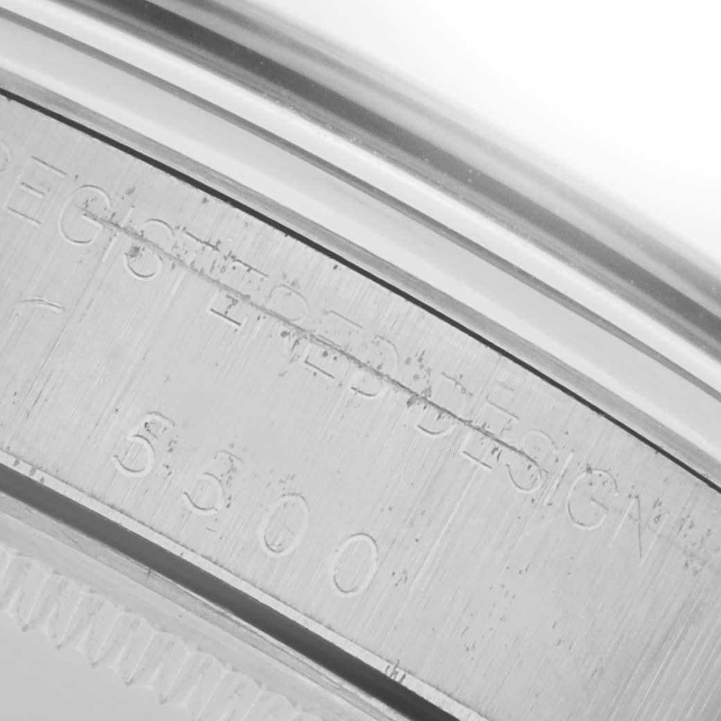 The image shows a close-up of the Rolex Air-King 5500 Men's Stainless Steel Silver Dial 5500 Men's Stainless Steel Silver Dial's engraved case side.