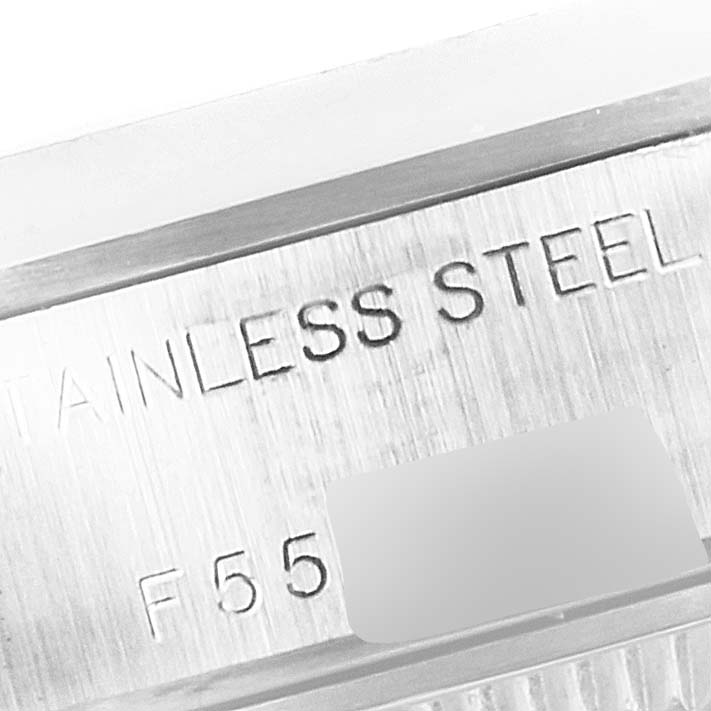 This is a close up of the Rolex Date 79160 Women's Stainless Steel Silver Dial 79160 Women's Stainless Steel Silver Dial model's inner casing, showing part of the serial and material engraving.