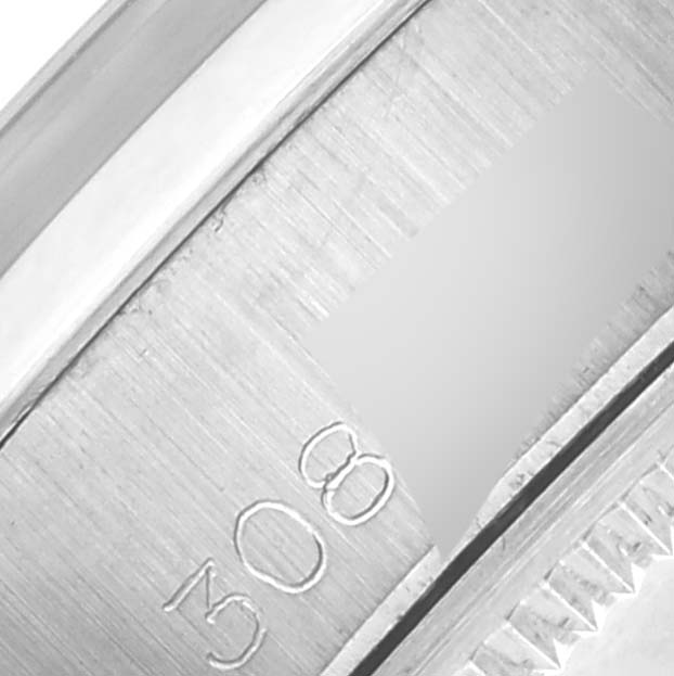 The image shows a close-up view of the Rolex Date 6916 Women's Stainless Steel Grey Dial 6916 Women's Stainless Steel Grey Dial model's edge, including markings and part of the case or bezel.