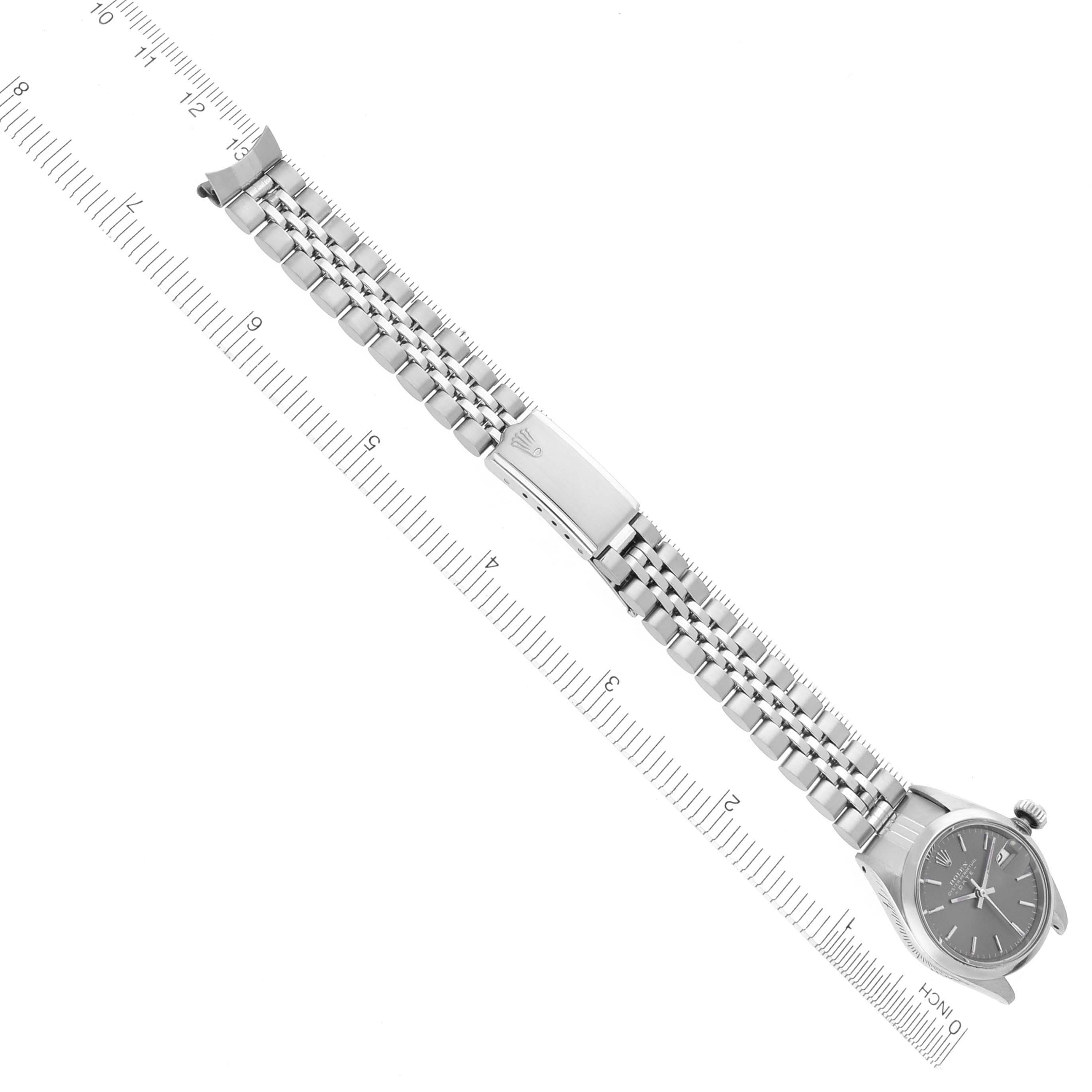 The image shows a Rolex Date 6916 Women's Stainless Steel Grey Dial 6916 Women's Stainless Steel Grey Dial watch, face and metal strap laid flat beside a ruler, highlighting the bracelet's length and clasp detail.