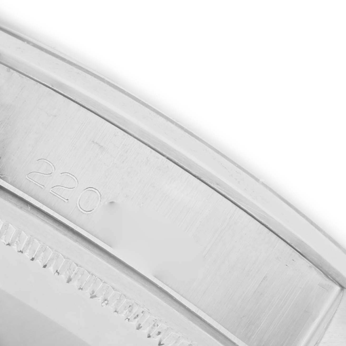 The image shows a close-up of the side of the bezel and casing with engravings on the Rolex Date 1500 Men's Stainless Steel Grey Dial 1500 Men's Stainless Steel Grey Dial watch.