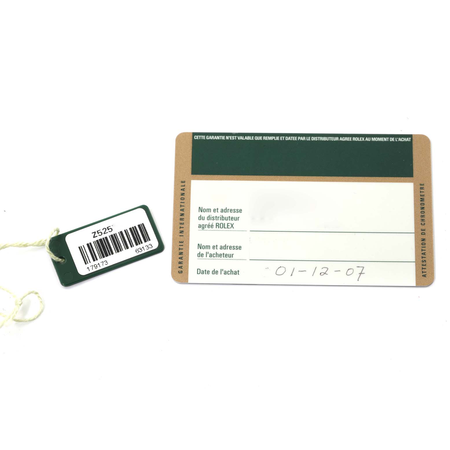 The image shows a Rolex Datejust 179173 Women's Steel and Gold (two tone) Champagne Dial 179173 Women's Steel and Gold (two tone) Champagne Dial warranty card and a green tag with a barcode.