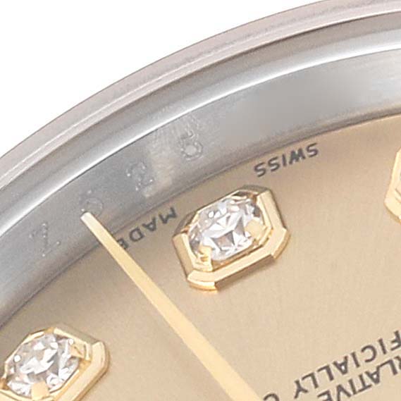This image shows a close-up of the dial, diamonds, and minute hand of a Rolex Datejust 179173 Women's Steel and Gold (two tone) Champagne Dial 179173 Women's Steel and Gold (two tone) Champagne Dial watch.