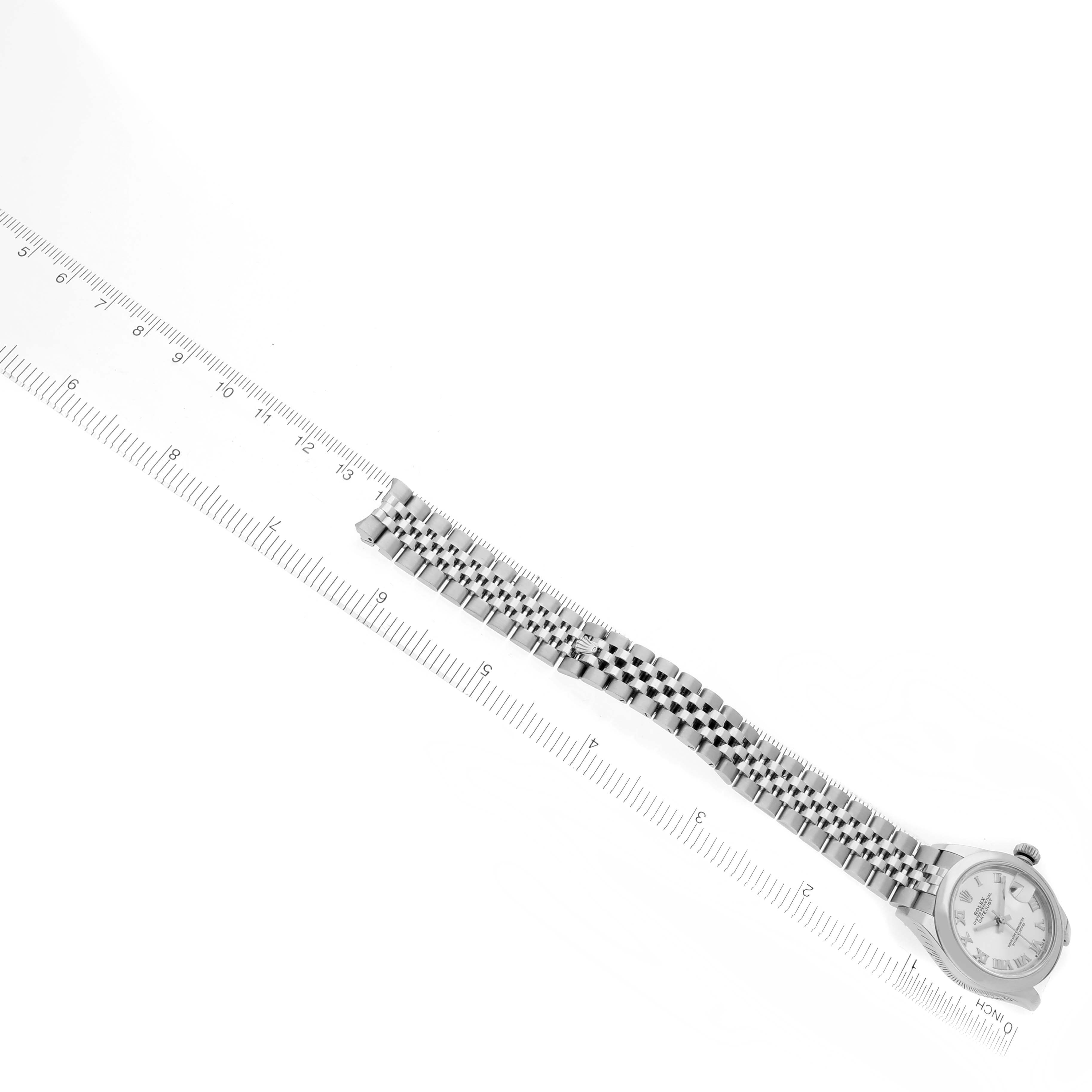 The Rolex Datejust 279160 Women's Stainless Steel Silver Dial 279160 Women's Stainless Steel Silver Dial watch is shown from an overhead angle with the face and bracelet visible, along with a measuring ruler.