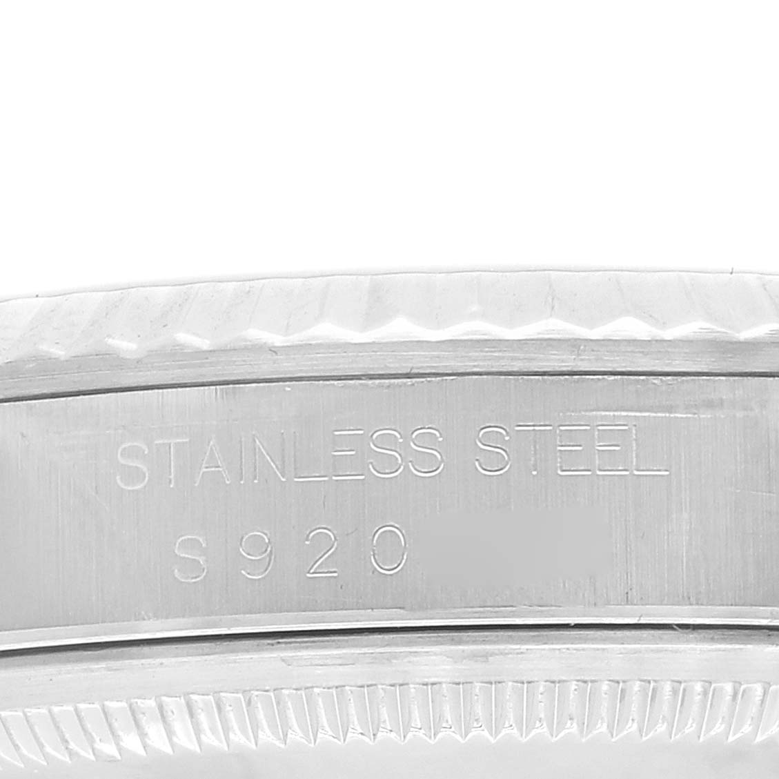 The image shows a close-up of the stainless steel case back edge of a Rolex Datejust 16234 Men's Stainless Steel Silver Dial 16234 Men's Stainless Steel Silver Dial watch.