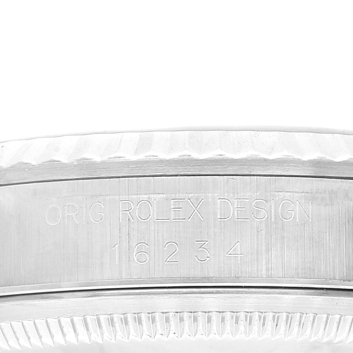 This image shows a close-up of the side of a Rolex Datejust 16234 Men's Stainless Steel Silver Dial 16234 Men's Stainless Steel Silver Dial watch with an engraving stating "ORIG ROLEX DESIGN" and the model number 16234.