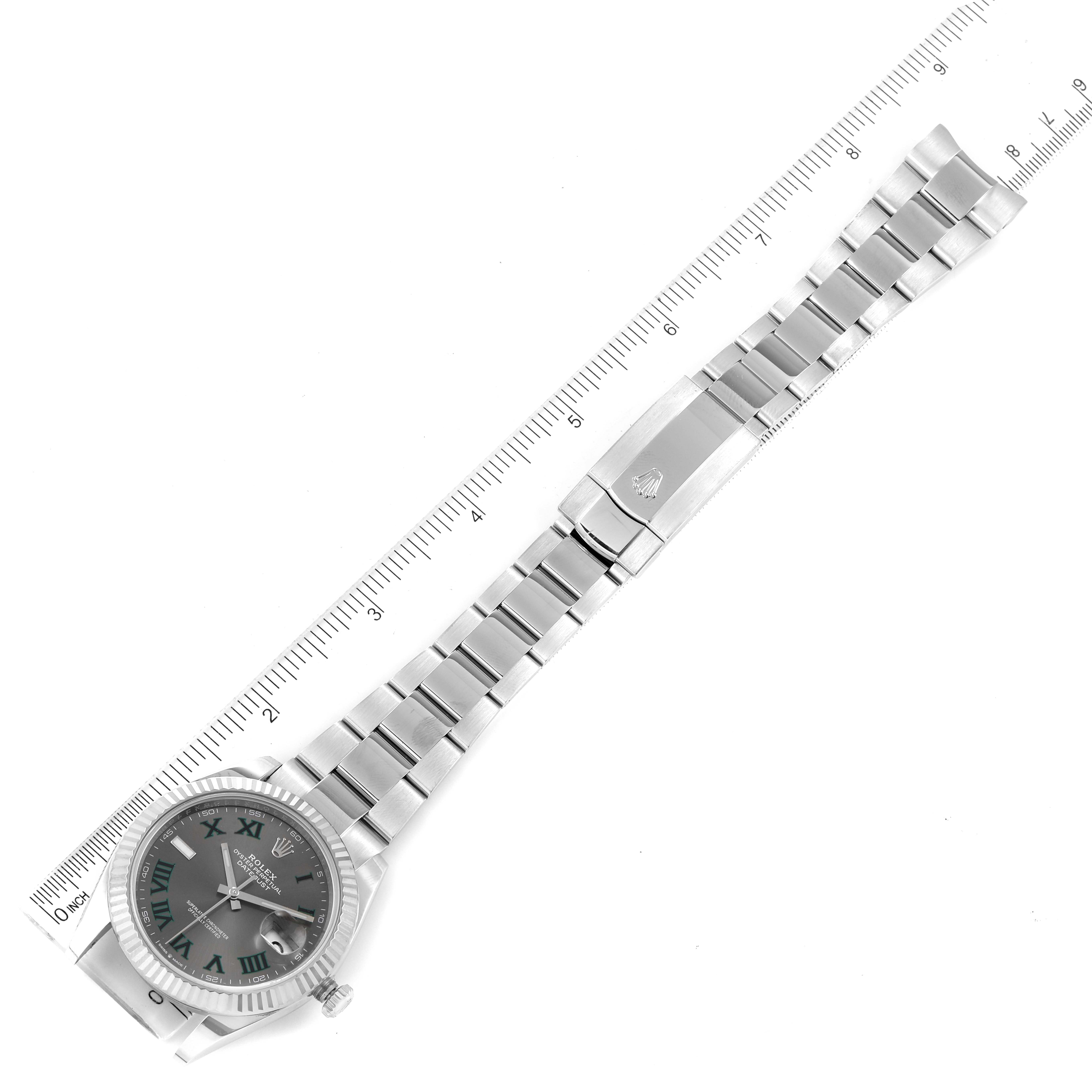 The image shows an overhead view of a Rolex Datejust 41 126334 Men's Stainless Steel Grey Dial 126334 Men's Stainless Steel Grey Dial watch with its entire band length extended alongside a ruler.