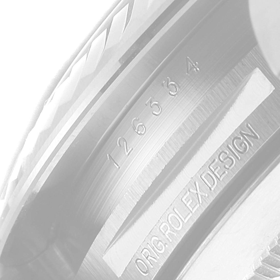 This is a close-up of the inner bezel of a Rolex Datejust 41 126334 Men's Stainless Steel Grey Dial 126334 Men's Stainless Steel Grey Dial, showing the model number and the engraving "ORIG ROLEX DESIGN."