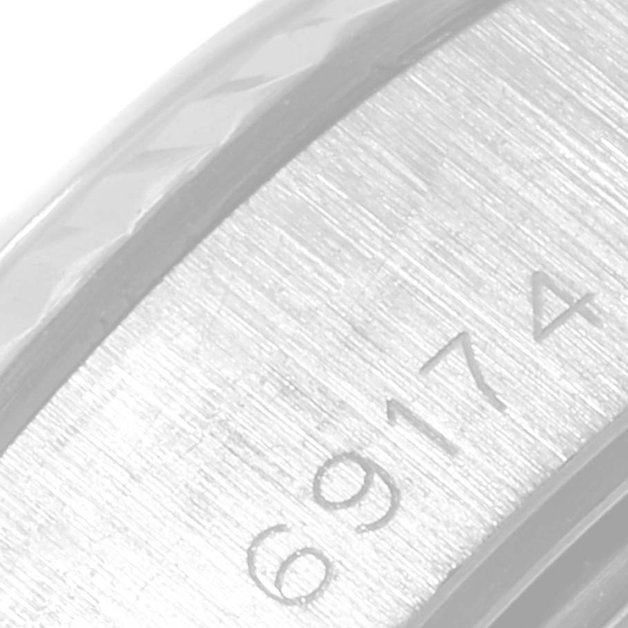 This close-up image shows the partially visible serial number and the edge of the bezel of the Rolex Datejust 69174 Women
s Stainless Steel Blue Dial 69174 Women
s Stainless Steel Blue Dial model.