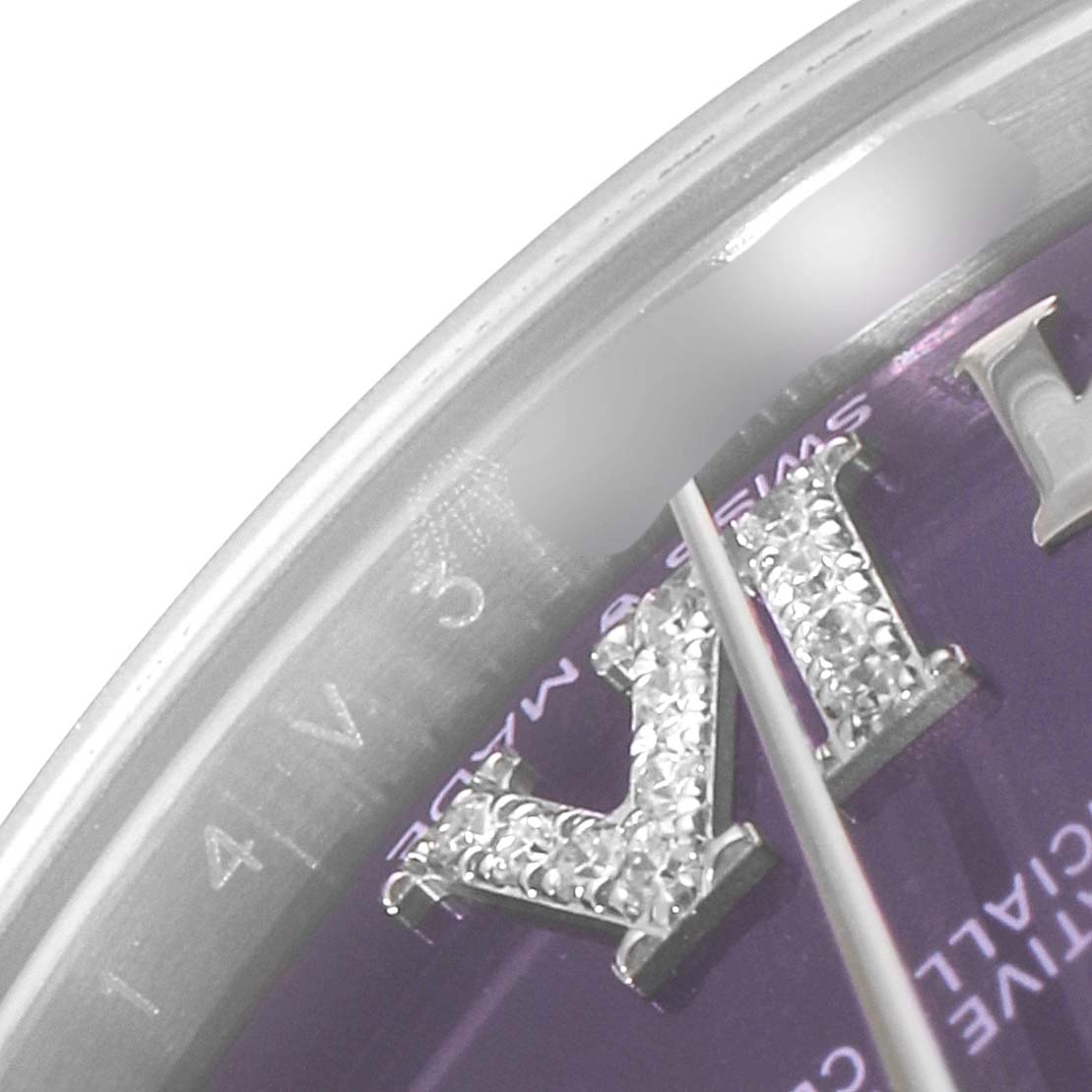 This image shows a close-up angle of the dial on a Mid-Size Rolex watch, highlighting the Roman numerals and texture.