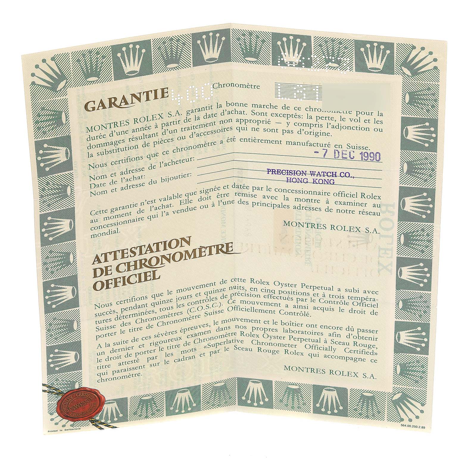 The image shows a warranty and chronometer certification for a Mid-Size Rolex watch, dated 1990, from an overhead angle.