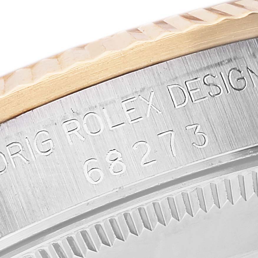 This close-up image shows the engraved side of the Mid-Size Rolex watch case with text and the model number.