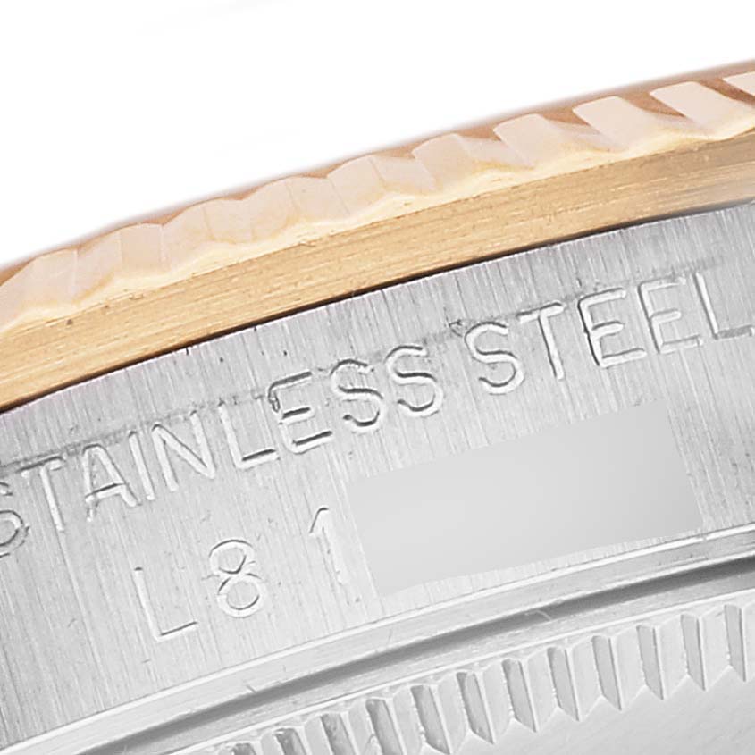 This image shows a close-up of the bezel and stainless steel casing of a Rolex Mid-Size 68273 Women's Steel and Gold (two tone) Grey Dial 68273 Women's Steel and Gold (two tone) Grey Dial model watch.