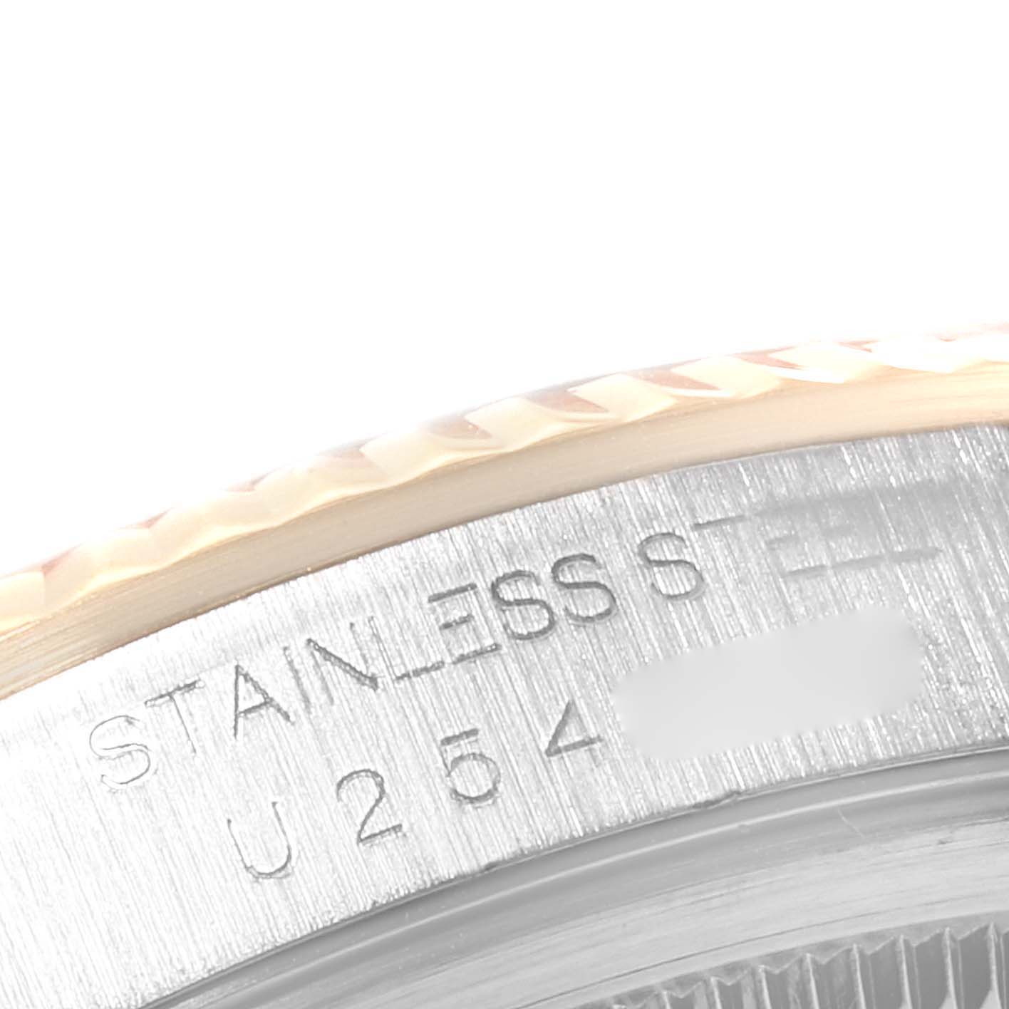 This image shows a close-up of the engraved stainless steel edge and fluted bezel of a Rolex Datejust 16233 Men's Steel and Gold (two tone) White Dial 16233 Men's Steel and Gold (two tone) White Dial watch.