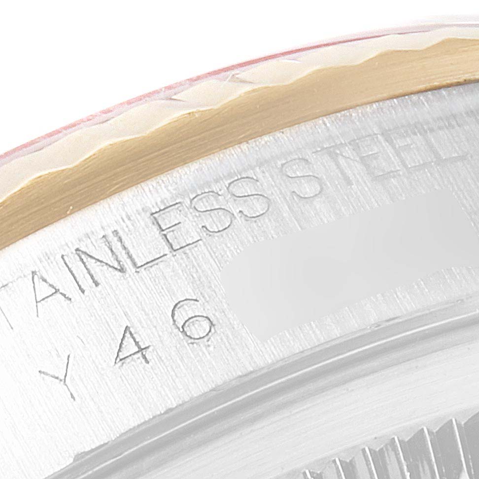 This close-up image shows the side of the bezel and part of the engraved serial on a Rolex Datejust 16233 Men's Steel and Gold (two tone) Mother of Pearl Dial 16233 Men's Steel and Gold (two tone) Mother of Pearl Dial model.