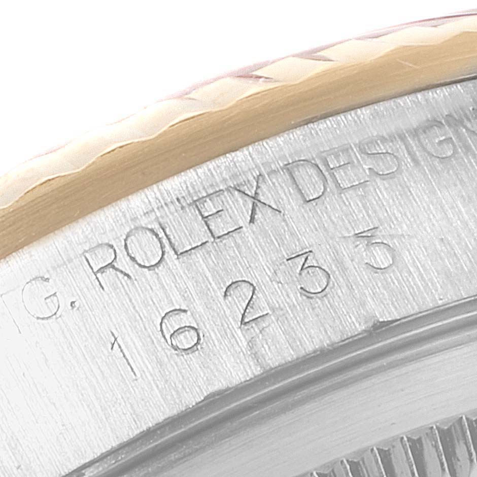 This image shows a close-up of the engraved text and fluted bezel on a Rolex Datejust 16233 Men's Steel and Gold (two tone) Mother of Pearl Dial 16233 Men's Steel and Gold (two tone) Mother of Pearl Dial watch.