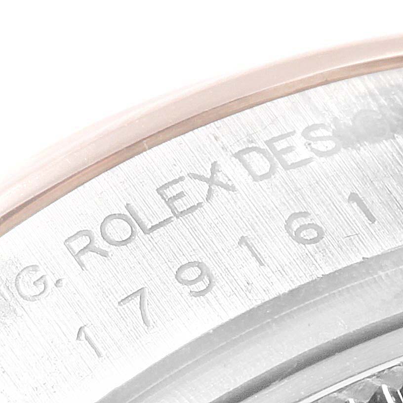 This close-up image shows the engraved serial number on the outer rim of a Rolex Datejust 179161 Women's Steel and Gold (two tone) Black Dial 179161 Women's Steel and Gold (two tone) Black Dial watch.