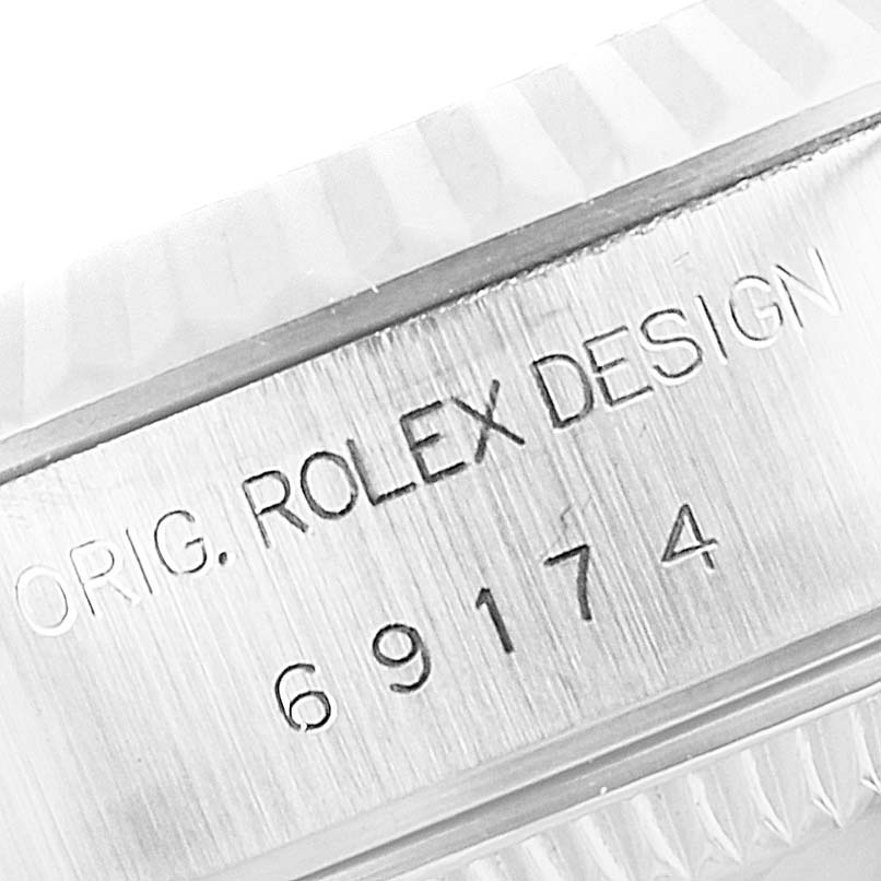 Close-up of the side engraving on a Rolex Datejust 69174 Women's Stainless Steel Silver Dial 69174 Women's Stainless Steel Silver Dial model, showing the text "ORIG. ROLEX DESIGN" and the model number.