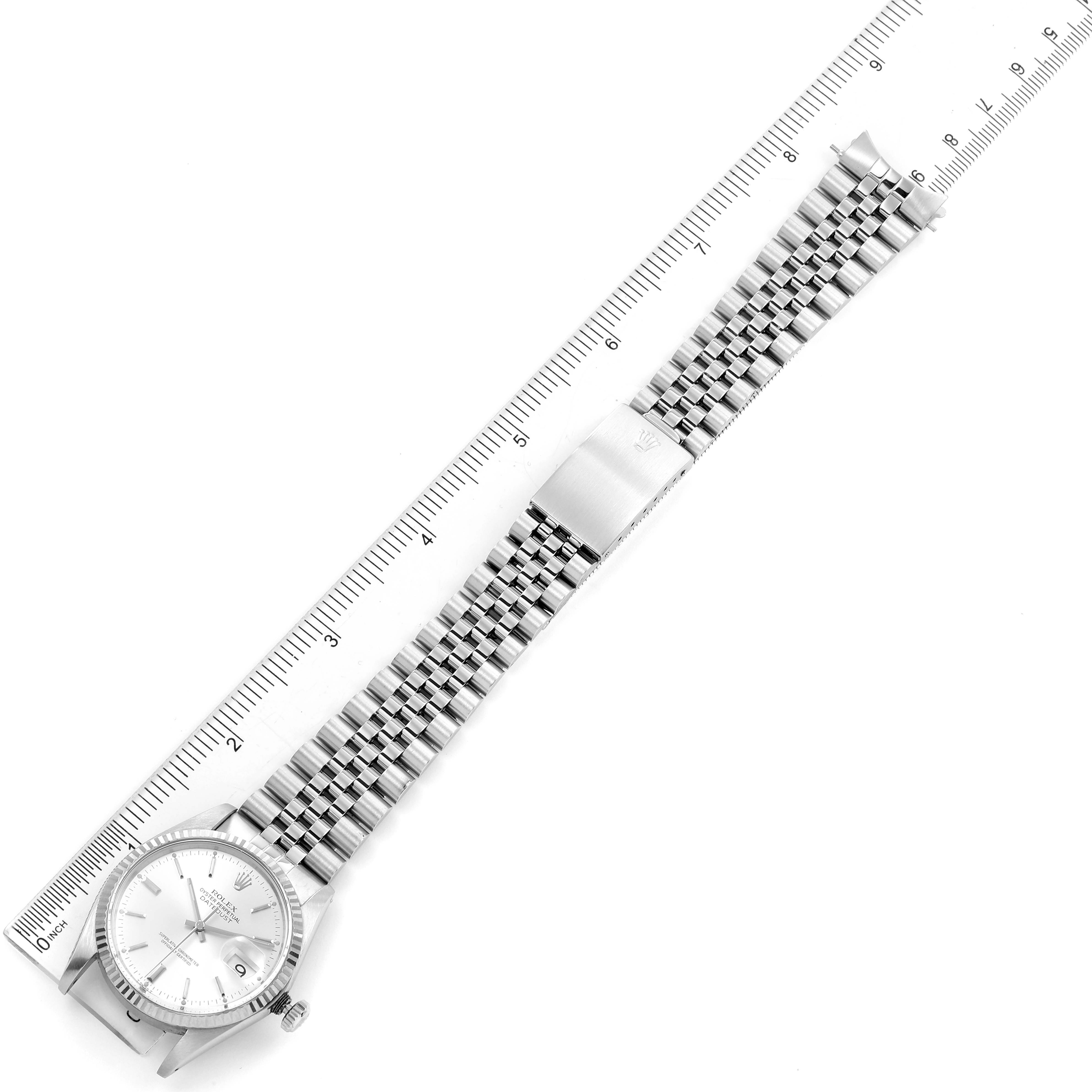 The Rolex Vintage Collection 16014 Men's Stainless Steel Silver Dial 16014 Men's Stainless Steel Silver Dial watch is shown from a top-down angle, displaying the face, bracelet, and clasp alongside a ruler for scale.