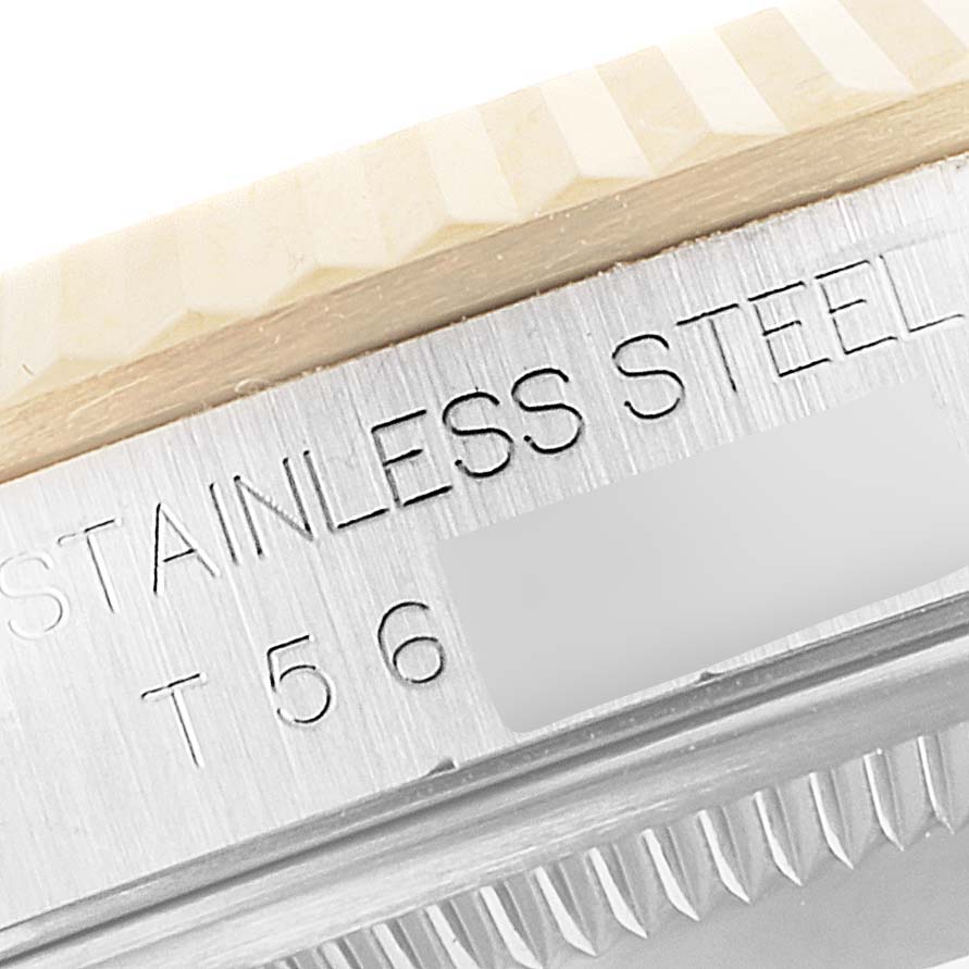 This close-up image shows the side view of the bezel and case of a Rolex Datejust 16233 Men's Steel and Gold (two tone) Champagne Dial 16233 Men's Steel and Gold (two tone) Champagne Dial model watch, highlighting "STAINLESS STEEL" engraving.