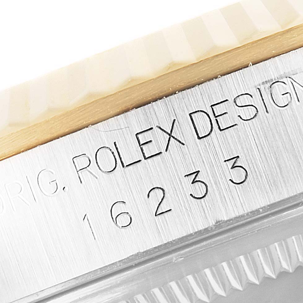 This close-up image shows the case edge and engraved bezel of a Rolex Datejust 16233 Men's Steel and Gold (two tone) Champagne Dial 16233 Men's Steel and Gold (two tone) Champagne Dial model, displaying its design reference number.