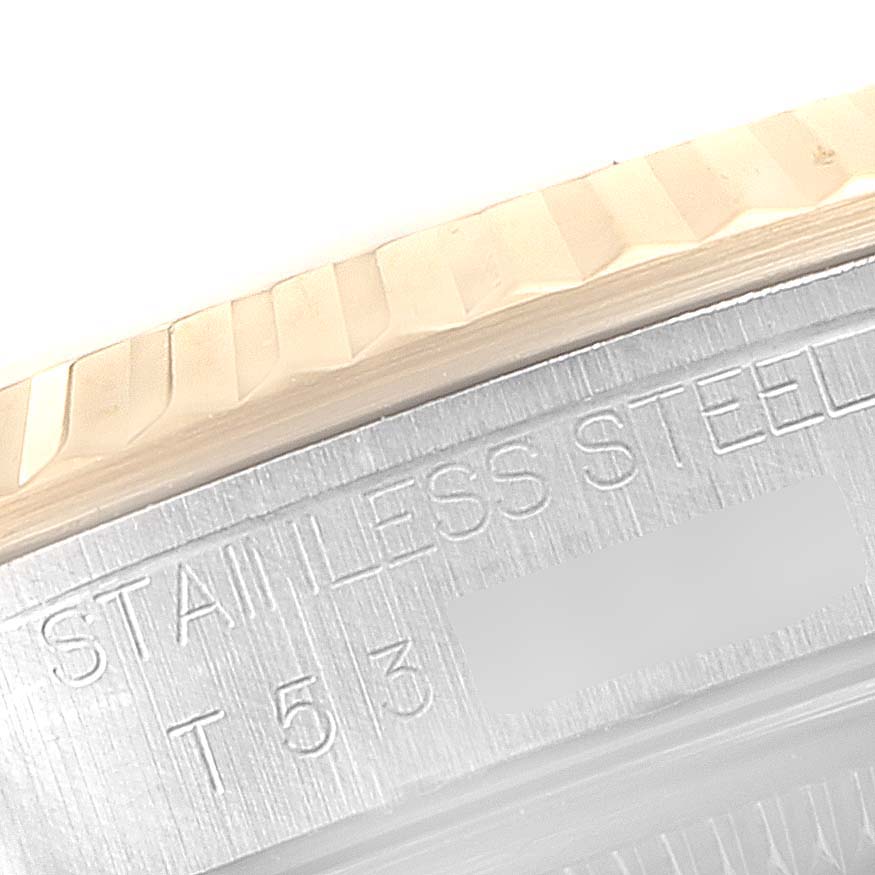 This close-up image shows the fluted bezel and part of the caseback inscription on a Rolex Datejust 16233 Men's Steel and Gold (two tone) Champagne Dial 16233 Men's Steel and Gold (two tone) Champagne Dial watch.