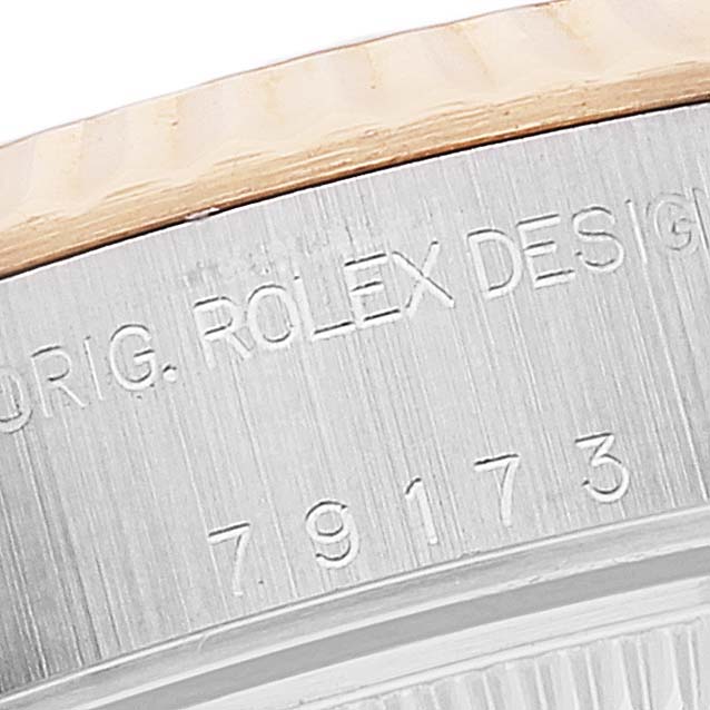 The image shows a close-up of the side engraving on a Rolex Datejust 79173 Women's Steel and Gold (two tone) Beige Dial 79173 Women's Steel and Gold (two tone) Beige Dial watch case.