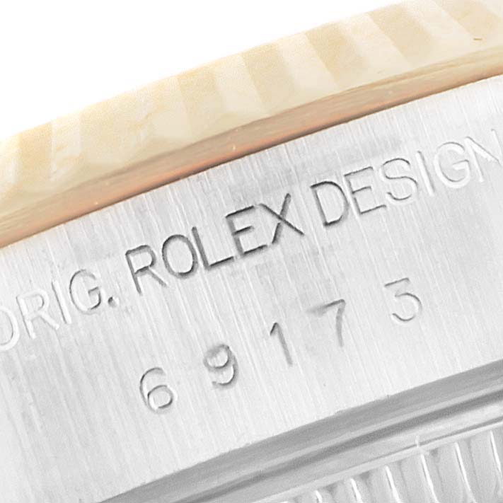 Close-up view of the Rolex Datejust 69173 Women's Steel and Gold (two tone) Silver Dial 69173 Women's Steel and Gold (two tone) Silver Dial model showing the bezel edge and engraved serial number.