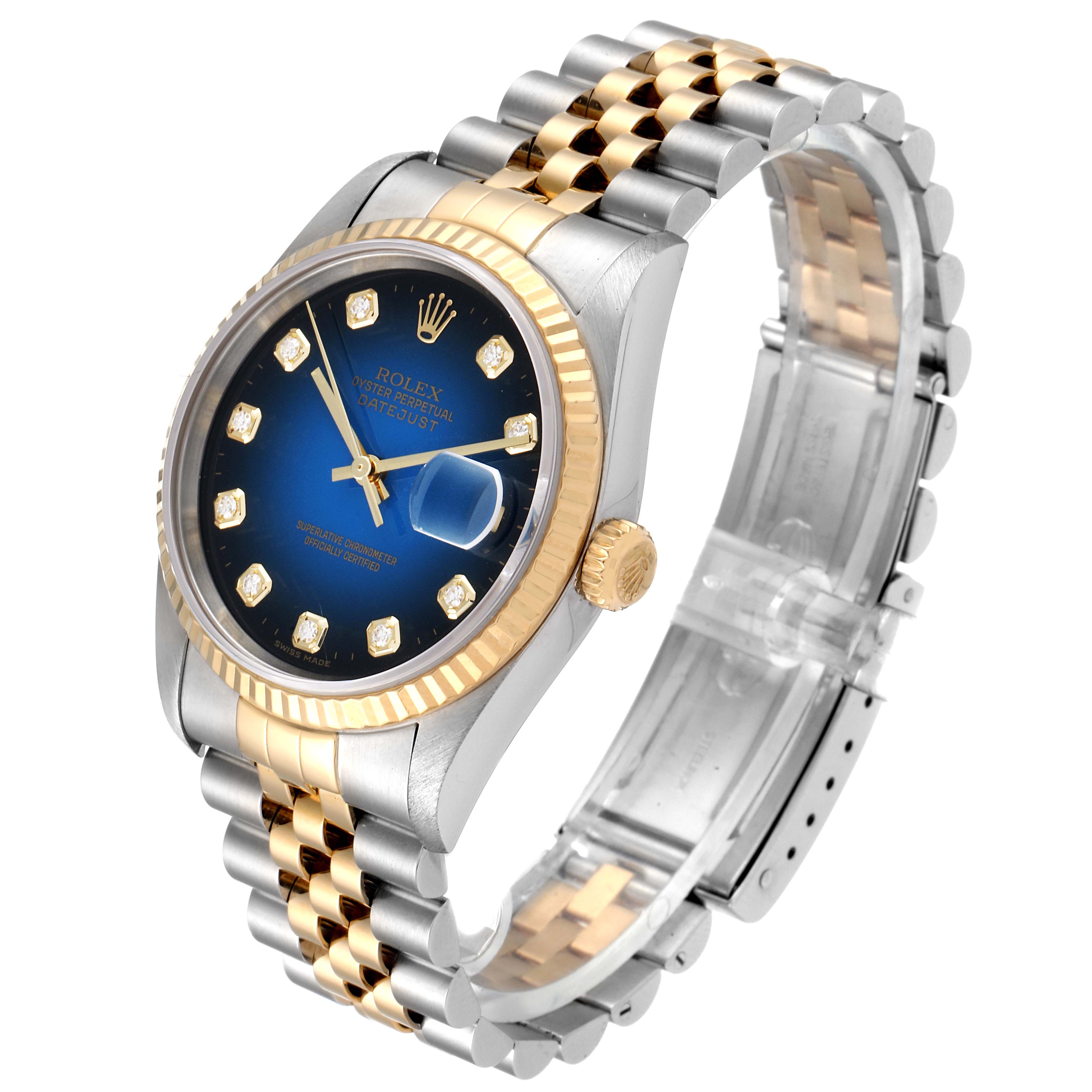 The image shows a Rolex Datejust 16233 Men's Steel and Gold (two tone) Blue Dial 16233 Men's Steel and Gold (two tone) Blue Dial watch at an oblique angle, highlighting its blue dial, gold bezel, and bi-metal bracelet.