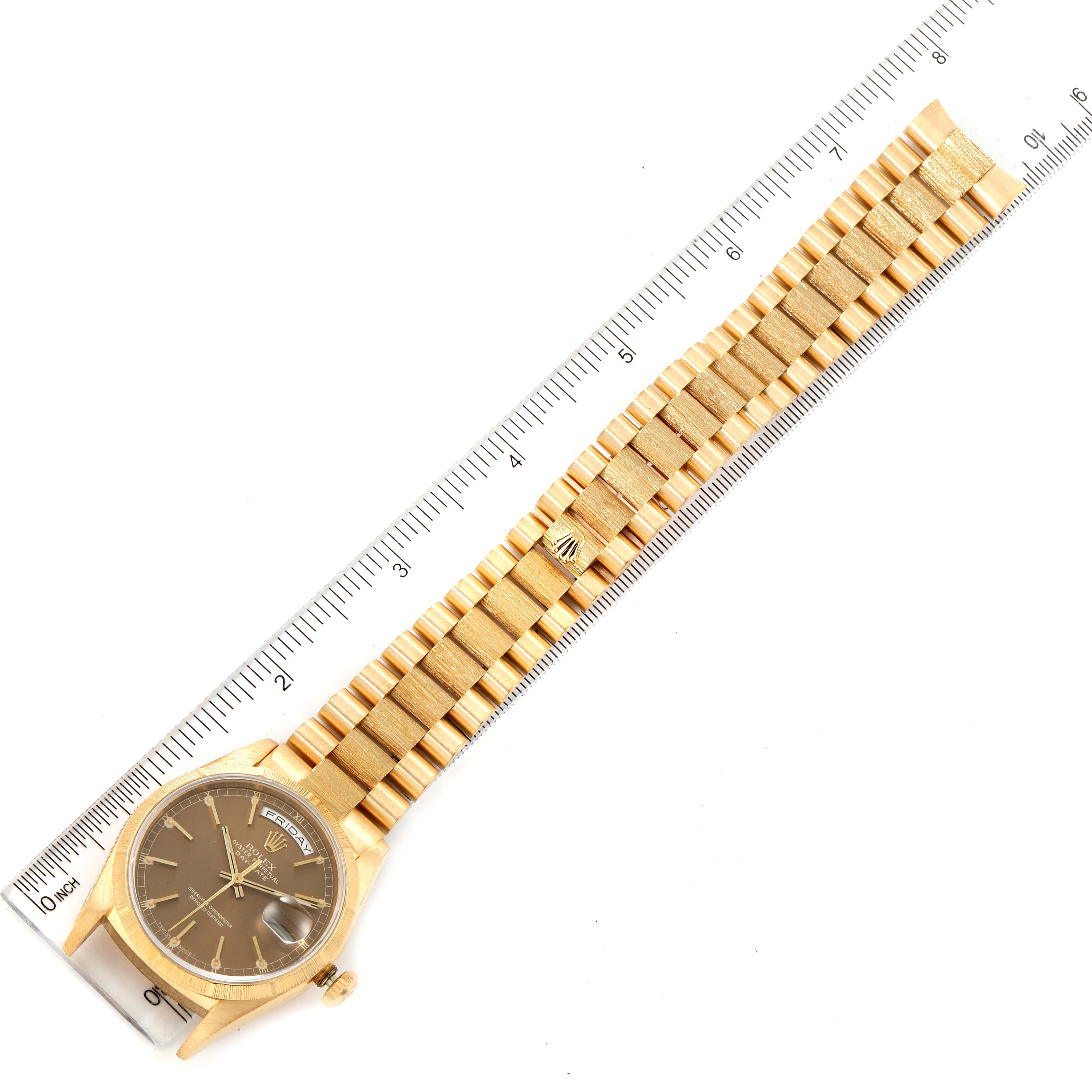 The Rolex President 18248 Men
s Yellow Gold Champagne Dial 18248 Men
s Yellow Gold Champagne Dial model watch is shown from an overhead angle, displaying the entire bracelet, dial, and a ruler for measurement.