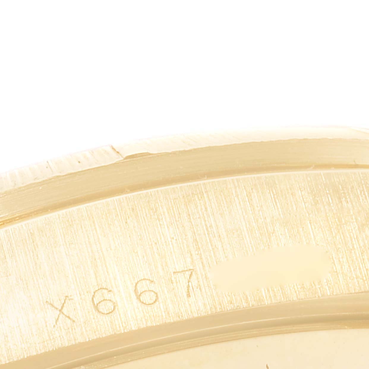 This close-up image shows the engraved serial number on the case side of a Rolex President 18248 Men
s Yellow Gold Champagne Dial 18248 Men
s Yellow Gold Champagne Dial model watch.